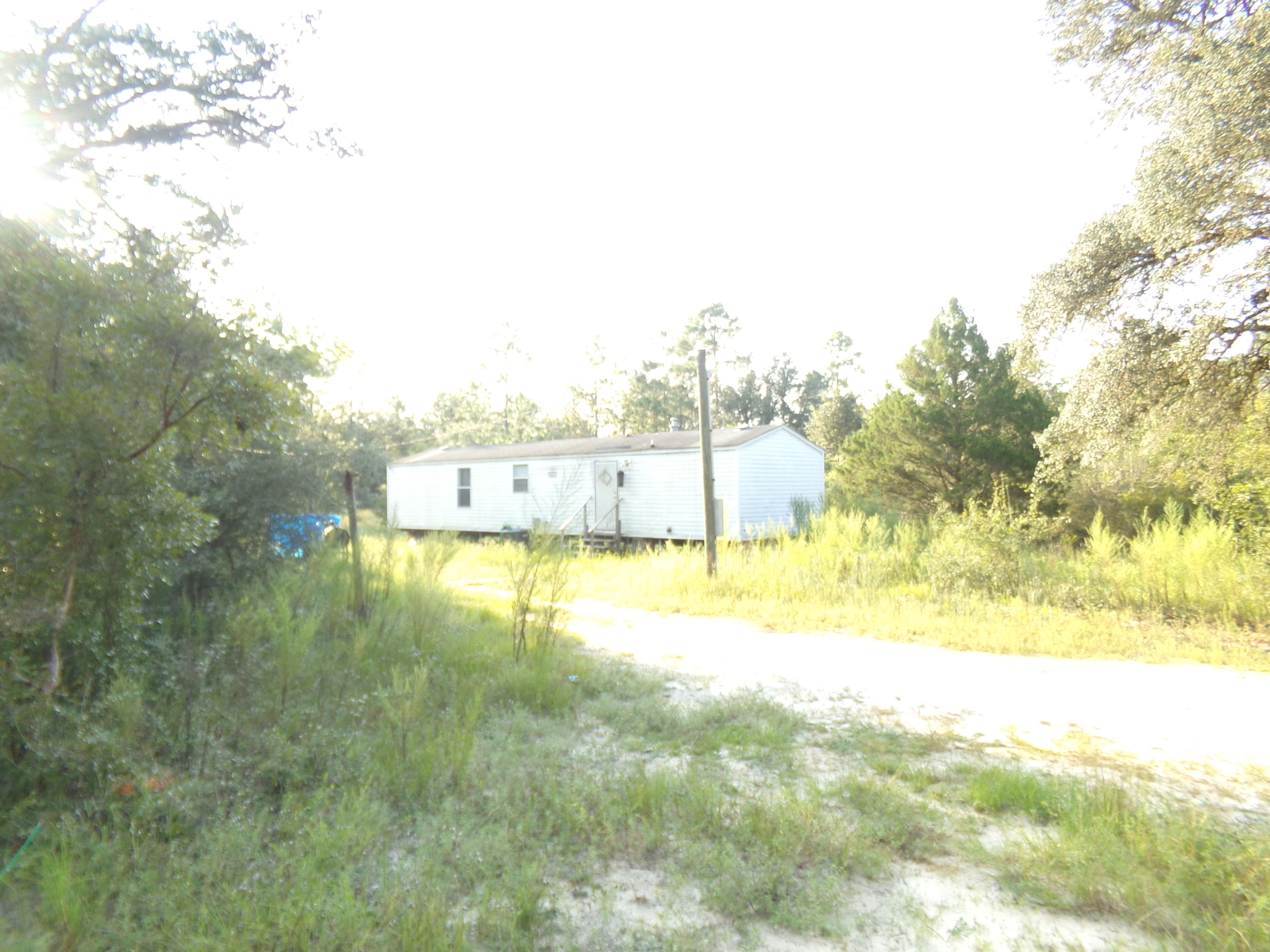If you are looking for privacy and seclusion this is for you~ The property is fenced, has single wide mobile home, septic tank, & well~ The property is wooded~ With some TLC this could be a great get away, or place to build your country home~ Being sold ''AS IS''~