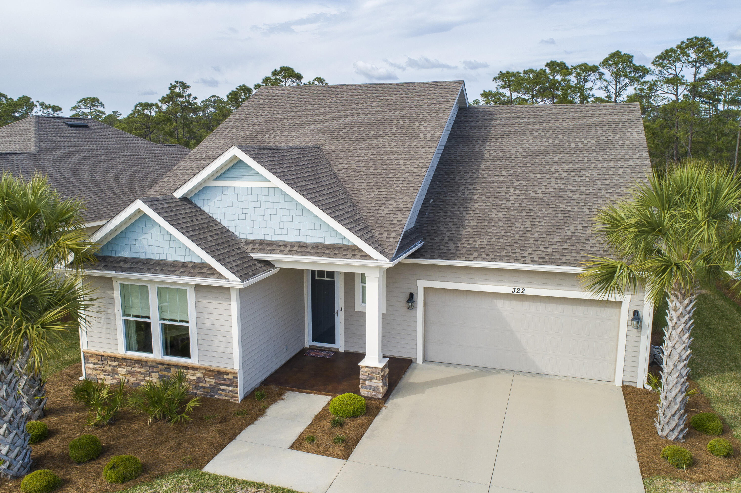 Beautiful Craftsmen-style home in immaculate condition on the west end of PCB, has 4 bedrooms 3 full baths and an attached 2 car garage. Granite counter tops in kitchen & baths, stainless steel kitchen appliances, luxury vinyl plank flooring throughout with tile floor in bathrooms, custom blinds, and many other upgrades. For added enjoyment an enclosed spacious screened in porch in the backyard which backs up to a natural preserve greenbelt. This is a Samuel Taylor Built home with 2x6 exterior walls, higher insulation rating, energy efficient, hurricane tie down and rod anchor system, and Kevlar-type hurricane shutters. Whisper Dunes is a highly sought-after neighborhood with a community pool that include restrooms and a covered cabana, a dog park, HOA maintains your lawn and landscaping.