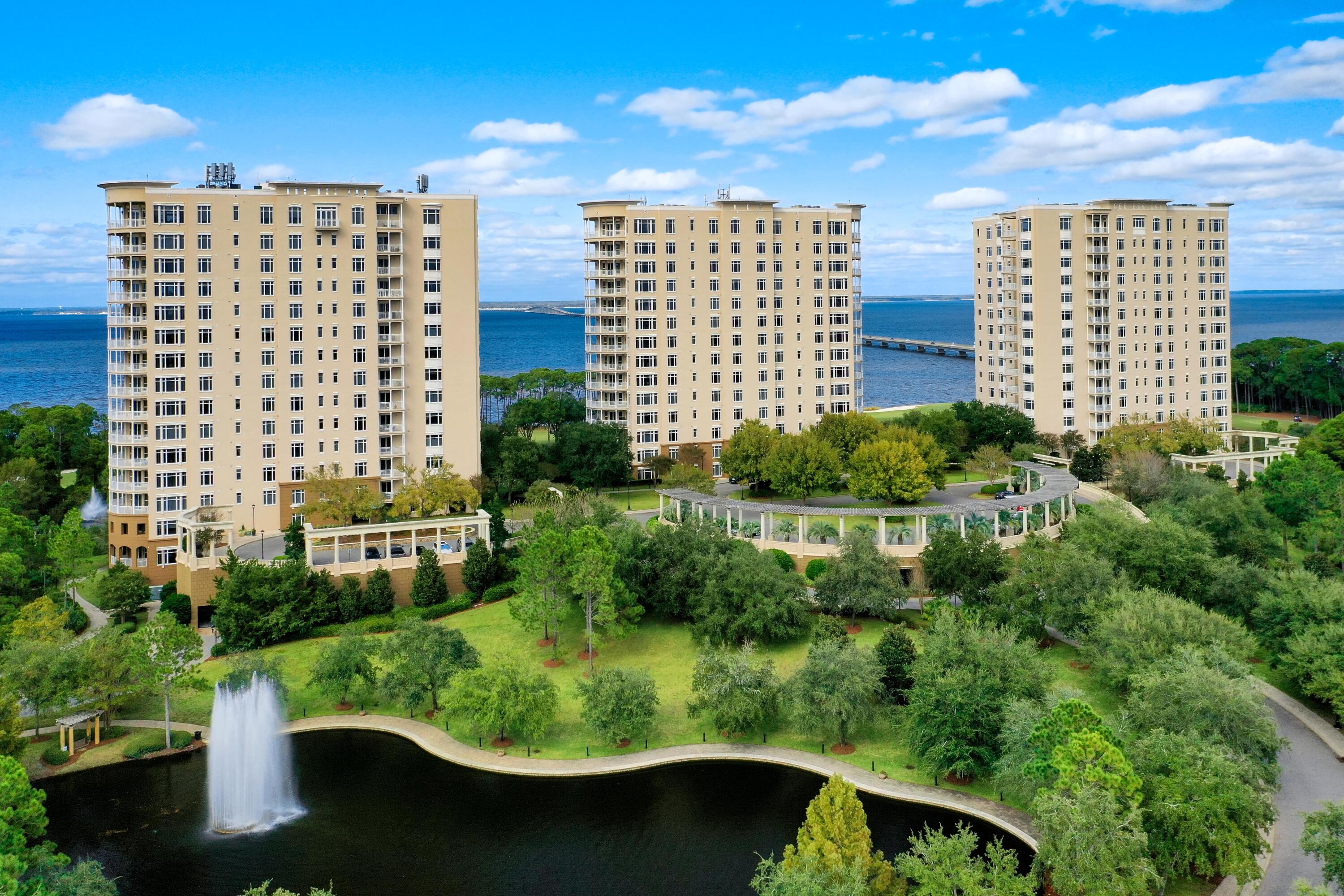 TURN-KEY OPPORTUNITY READY FOR YOUR USE & ENJOYMENT!  From its prime orientation on one of the highest floors of One Water Place, this luxurious condominium residence enjoys sweeping views of the Gulf of Mexico, Choctawhatchee Bay, the Fred Couples Golf Course, natural preserve areas, and the gorgeous Emerald Coast sunsets! Featuring the popular Castleton floorplan, in a calming neutral palette, the beautiful interiors complement the stunning views. Highlights include a large living area surrounded by expansive windows and a curved balcony, a beautiful formal dining room delineated by columns and featuring full-length windows, and a luxurious kitchen with granite countertops, attractive tile backsplash, large breakfast bar and stainless Viking Professional appliances. The master suite... has its own hallway with built-ins, direct balcony access, and large bathroom with soaking tub, enclosed shower, double vanities & sinks and a spacious walk-in closet. Two additional bedrooms each have their own bath, plus there's a beautiful home office, which could convert into a fourth bedroom or secondary media room. The residence features quality finishes and fixtures and upgrades, such as gorgeous hardwood flooring.  This amazing residence offers the very best of Destin's premier One Water Place community, in addition to the fabulous amenities and an incredible lifestyle within the master-planned golf community of Kelly Plantation, all in an ideal setting along the Emerald Coast of Florida!