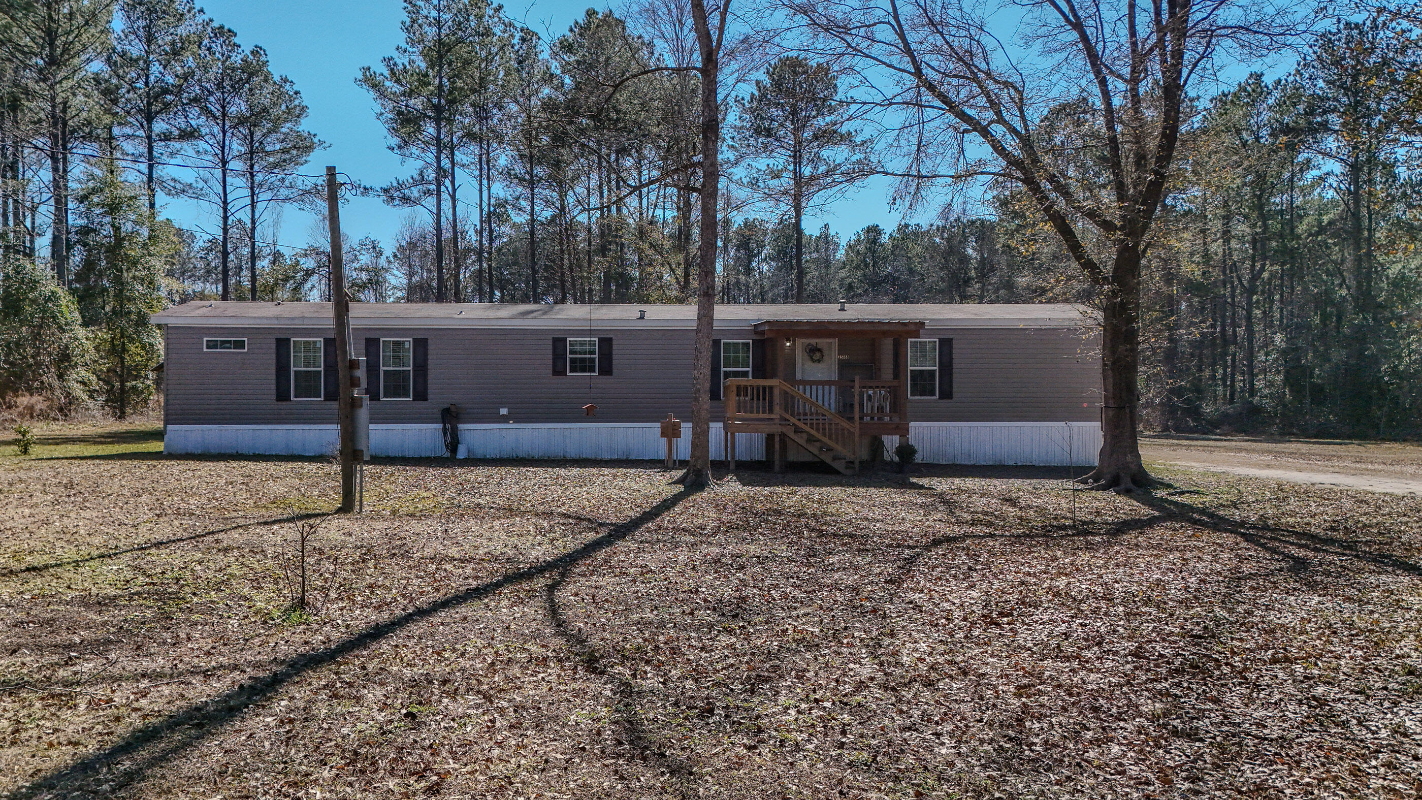 3BR, 2BA mobile home offering 1,248 sqft sitting on 8.09 acres. Home welcomes you with a large covered front porch to a great open floor plan. Home has upgraded kitchen cabinet, large breakfast island, and includes a separate eat in area plus tons of built ins and storage. The living room separates this split floor plan, and the master offers not only a large bedroom but custom shower! Home is move in ready! The rear of the home offers a large covered back porch overlooking your acreage that includes a pole barn for storage as well! Less than a mile from Lake Jackson makes this perfect for weekend fishing trips. Property also offers excellent versatility. Zoned mixed-use, looking for a peaceful residence on acreage or an investment opportunity- this one has both!