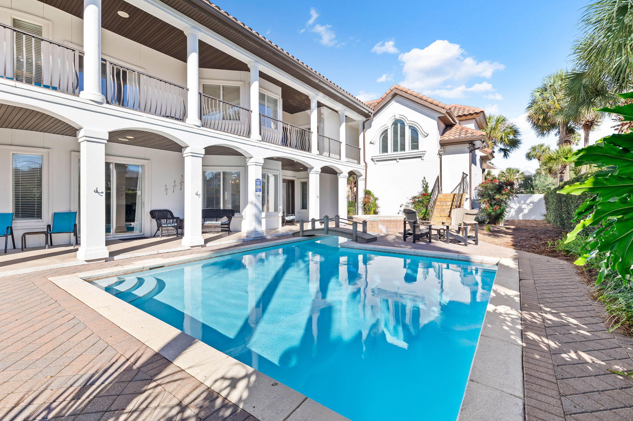 48 Tranquility Lane is an exceptional coastal retreat offering 5 bedrooms, 3.5 bathrooms, and over 3,400 square feet of thoughtfully designed living space, making it perfect for families and guests to enjoy. This stunning property features one of the most impressive private pools in the area, complete with a spillover spa, a picturesque footbridge, and a 6-foot privacy fence, ensuring a secluded outdoor oasis like no other. Recent updates, including new luxury vinyl flooring, fresh paint, modernized mattresses, and a high-efficiency pool heater, further enhance its luxury and comfort. This home has $155,000 + booked in 2024 with rental income ranging from $150K-225k annually in gross rental history. The first floor showcases an open-concept layout with a chef's kitchen featuring exotic granite countertops, flowing seamlessly into a spacious living room complete with a flat-screen TV and fireplace. The dining area overlooks the private courtyard and pool, creating an ideal setting for entertaining or relaxing. This level also includes a laundry room, a bedroom with full-size bunk beds, and a half bathroom. On the second floor, two expansive primary suites await, each with king-sized beds and private ensuite bathrooms. The primary suite above the garage also includes a cozy sitting area with a sectional and a queen sofa sleeper. Two additional bedrooms, one with two queen beds and another with a king bed, provide ample and flexible accommodations.

Professionally decorated with custom furnishings and meticulous attention to detail, the home exudes sophistication. High-speed internet ensures seamless connectivity, while an additional refrigerator in the garage adds practicality. Outside, the home's extensive living spaces and extraordinary pool area offer endless opportunities for relaxation and entertainment. Situated just across the street from the beach and a short distance from Club Destiny, the property provides access to a wealth of community amenities, including a state-of-the-art clubhouse, fitness center, seasonally-heated swimming pool, tennis and basketball courts, a putting green, a children's playground, and even a private 25-seat IMAX theater.

Located in one of the most sought-after neighborhoods, 48 Tranquility Lane combines luxury, privacy, and convenience. Whether lounging in the secluded courtyard, enjoying the nearby white-sand beaches, or exploring the exceptional amenities of the area, this home offers the ultimate coastal lifestyle.

Contact us today for rental projections & cost-to-own figures.