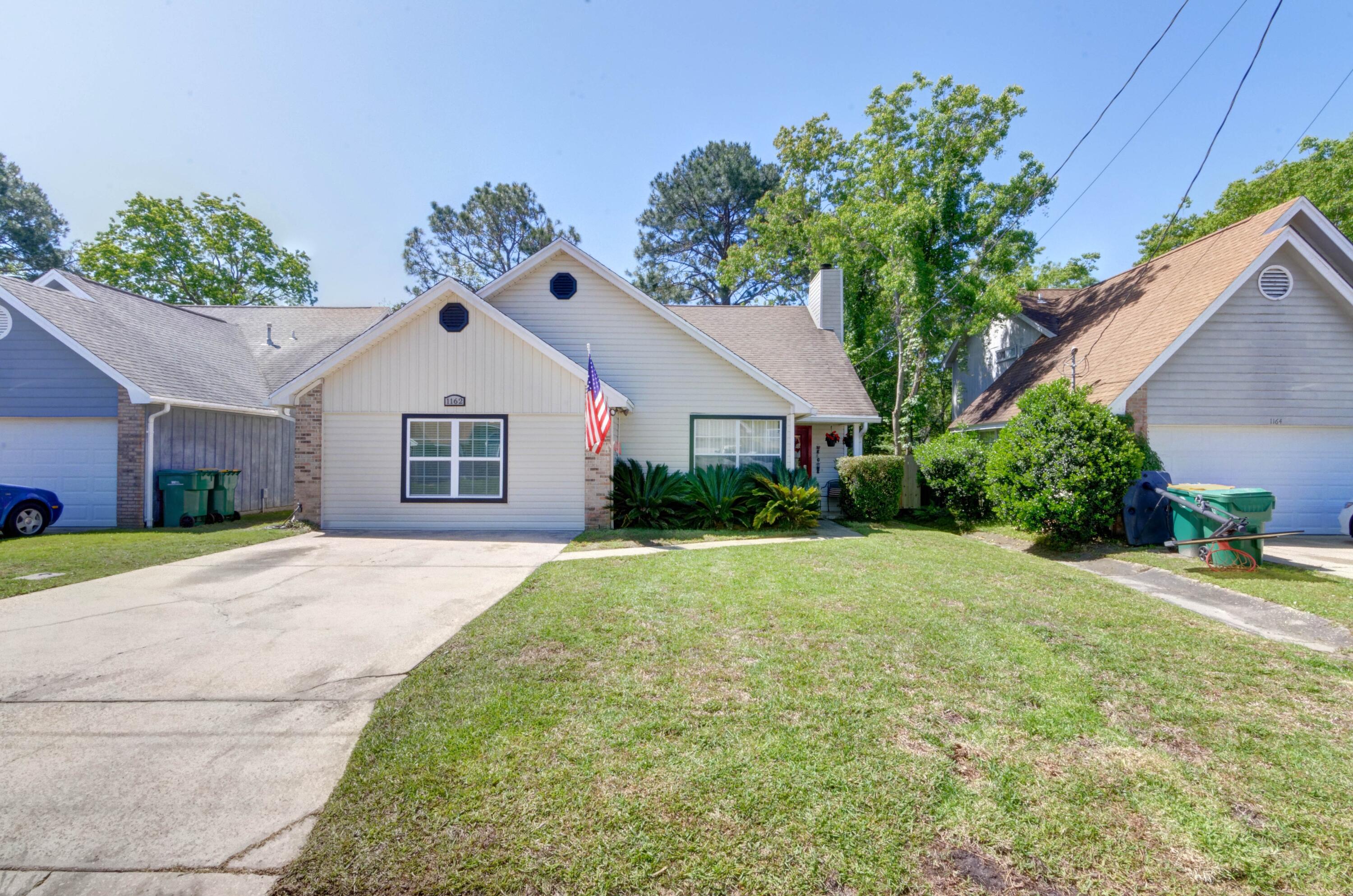 Welcome to this charming 4 bedroom Fort Walton Beach home perfectly located in Saddle Creek a short drive to Hurlburt Field!  Full of owner renovations, this adorable retreat is move in ready and you'll have peace of mind with a water heater replaced in March 2021, and two HVAC systems less than a year old. Roof is 2006. Enter the front door and you'll love the large open living room with wood look tile throughout and the wood burning fireplace. The kitchen has been fully renovated with new cabinets, counters, and stainless appliances. There are two master bedrooms as the garage has been beautifully converted into a fantastic room! The other two bedrooms are a nice size with tile floors and a shared bathroom. The interior laundry is extremely spacious and has plenty of room for storage. The covered patio has been enclosed and is ready for you to finish, and you'll love the fenced in backyard and large workshop! Don't delay in calling this your new home!
