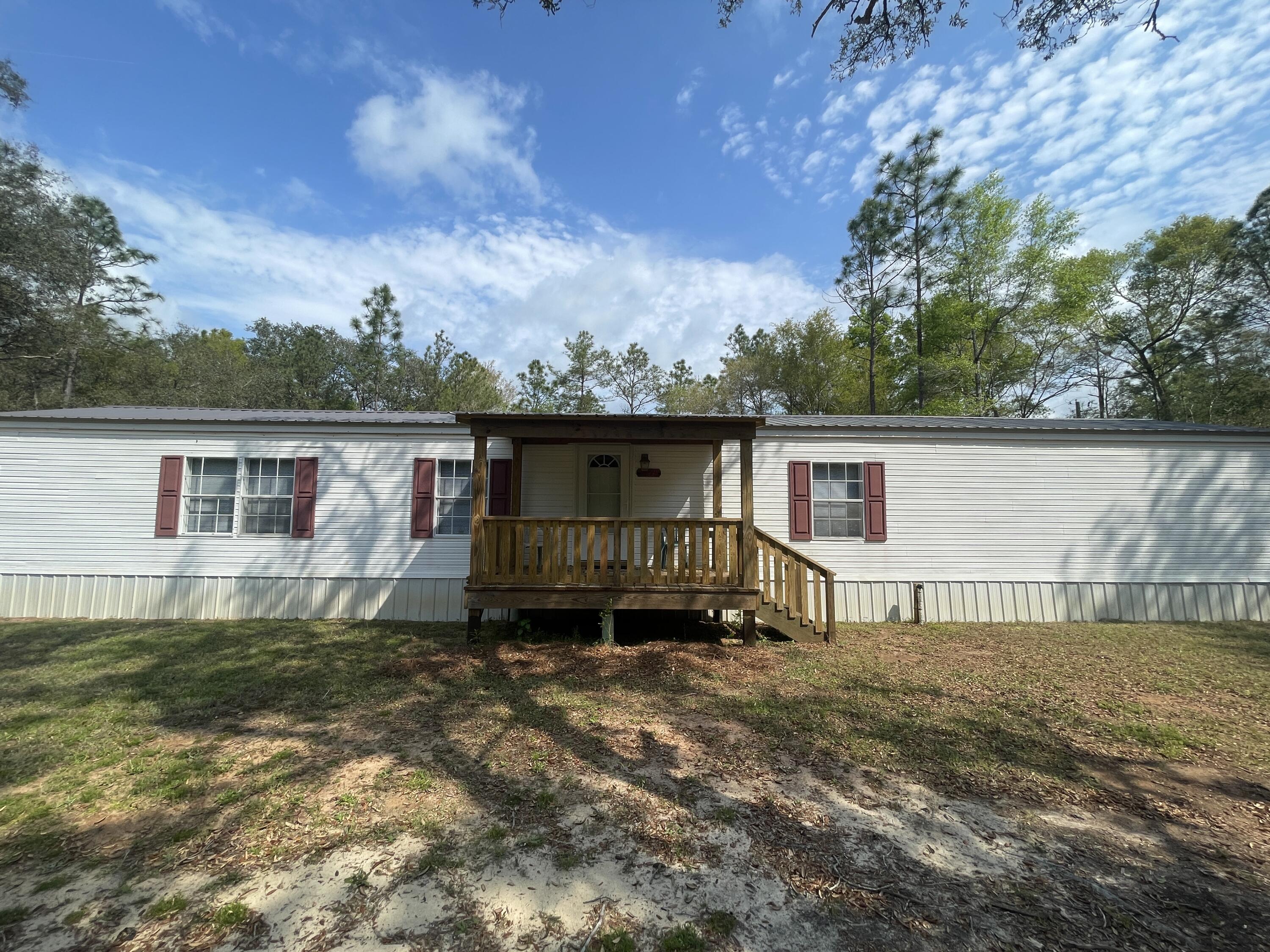 Charming 2-bedroom, 2-bath home tucked away in the serene woods of Holt, Florida! Embrace the tranquility of nature with the lush surroundings, inviting the melody of birds and the relaxed pace of country living. This cozy dwelling boasts covered front and back porches, creating delightful outdoor spaces, along with a convenient outdoor storage shed.

Inside, the home exudes warmth with a spacious living room, a fully equipped kitchen featuring a flat cooktop stove, ample cabinet and counter space, a formal dining area, and laundry hookups for added convenience. The primary bedroom is generously proportioned, offering a sense of retreat with a large walk-in closet and its own en suite. The guest room is equally inviting, and a well-appointed full guest bath complements the living space.

Maintain a fresh and clean environment as smoking, including vaping, is not permitted.

Discover the allure of country living in this adorable Holt retreat, where comfort and natural beauty harmonize to create a welcoming haven.
