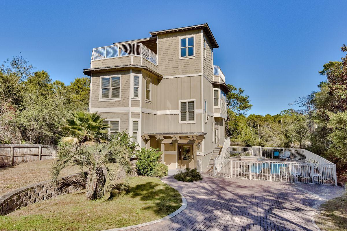 JUST REDECORATED & REFRESHED! Standing four stories tall over Big Red Fish Lake, this custom Beach house features 4,300 sq. ft. (heated/cooled), w/2,000 sq. ft. of decks/porches. Privacy galore is afforded by a wooded lake access on the southern border of the property, so no home will be built next door. A fabulous rental property boasts two large living areas, 5 bedrooms, 4 baths, and 2 half baths. Exterior finish stucco and hardy plank siding with shake accents are attractive with a galvalum metal roof, trellis canopy with wooden decks, 14 x 20 pool, pool deck, aluminum railing, elevator, and a private dock/pier is allowed. Great fishing & boating in Redfish Lake. The 1st floor has large storage areas, a big game room or another bedroom, kitchenette, bunkroom, and laundry. Access the pool/hot tub area via steps from the 2nd floor, in addition to the laundry, Master Suite, 2 bedrooms, and 2 half baths. You'll dine and entertain on the 3rd floor in the spacious great room, kitchen, dining area, and living area with half bath. Relax in your private Master Suite and Bath also on the 3rd floor. Interior features include granite countertops, tile floors in game room and baths, hardwood floors in great room, kitchen, dining, stairs and hallways, and all GE Profile appliances. Your family and friends can enjoy the magnificent lake and area views from the roof top deck that with an outdoor kitchen/wet bar, gas grill storage area, and covered area. The dock shown in the photos is on the lot on the north side of house and does not belong to this property; however, one can be added to this property!  Walk to Beach access only six lots or one block away.