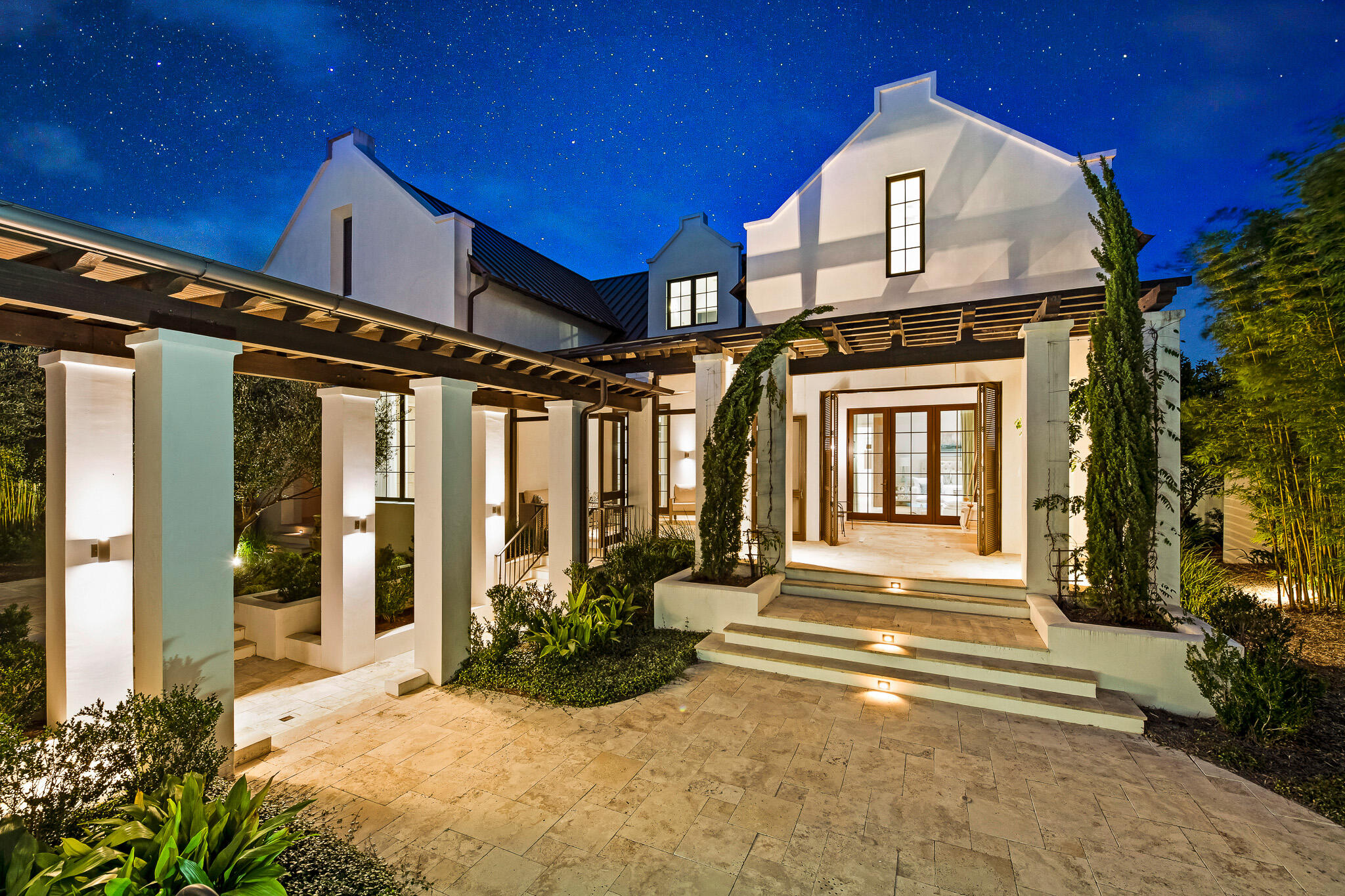 Welcome to 288 Walton Rose Lane; an architectural masterpiece designed by A Boheme Design and built by Galvas Construction and located on the East end of 30A. Just steps away from Rosemary Beach, this home is built with intention and elegance. Completed in 2018, this truly unique home offers privacy in a secluded compound in the heart of Inlet Beach and is located mere steps to Rosemary Beach. 288 Walton Rose Lane features five bedrooms, six bathrooms, and 4,467 SF. 

Walking in, this gorgeous property greets you with an impeccably lush landscape; featuring mature citrus trees, olive trees, privacy bamboo and outdoor lighting which further enhance the splendid outdoor space.

Buyer to verify all information and dimensions. Information is deemed reliable but not guaranteed. Heading inside, this grand home welcomes you with the intricacy of the exposed beams and soaring cathedral ceiling of the great room dining and kitchen area. 

Perfect for entertaining; the first floor features an outstanding great room, living and dining space, and kitchen. The great room features an impressive wall of 10ft windows, where sunlight pours in and illuminates the space, and a gorgeous gas fireplace- perfect space to gather around with family! The great room also features Venetian plaster walls and travertine stone flooring throughout. The Chef's kitchen features a massive marble island with seating, Wolf and Sub Zero appliances, ice maker, farmhouse sink, antique copper faucet and pot filler, two large warming drawers, two dishwashers, and endless storage. The adjacent laundry room/pantry with large capacity washer and dryer and separate sink also provides additional storage and organization for the home.

The cutting-edge, luxurious Chef's kitchen also features a beautifully-designed custom wood and marble bar area with convenient refrigerator drawers, sink, ice maker and two wine refrigerators, Adding to the beauty of the bar area you will find a stained pecky cypress ceiling. Additionally, the great room features a powder room- perfect for when you're entertaining guests! The first floor powder room features an oak slab ledge and a freestanding limestone sink. 

The first floor also features a remarkable master suite, which is complete with a separate sitting/office area, exposed beams, two expansive walk-in closets with built-in drawers and shelving, and a separate water closet. The stunning master bath features Calacatta marble throughout, a separate double slipper tub alcove with a gorgeous chandelier above, two separate sink/storage areas, a separate vanity area, and an oversized shower with bench seating. From the master bedroom you can step out to the enclosed sleeping porch and relax on the delightful bed swing. The home also features an oversized screened porch with a built-in Wolf grill and plenty of room for entertaining. Step outside to the large outdoor space which is enhanced by a gorgeous water feature and stone pavers.

Head upstairs to the second floor where you'll find an open sitting area, and two additional bedrooms both with beautifully appointed en-suite baths.

This gorgeous home also features a fully-finished epoxy-floor, 3-car garage with an additional washer and dryer and a unique elevated tiled dog washing area. The home also features a carriage house- located above the garage. The carriage house features white oak flooring, two master suites with marble finished en-suite bathrooms, an open concept vaulted living area with exposed beams, and a kitchen with marble counters and stainless steel appliances. Guests in the carriage house can enjoy the large balcony and the two covered porch areas.

This gorgeous home is built and certified to category 5 standards and features impact windows throughout the property. This home was built with luxury and safety in mind- providing you with a strong peace of mind! Additionally, this home features a whole-house 30kw Briggs Stratton Generator and the state of the art security system with security cameras. And last but not least, the home also features 3 Rinnai hot water heaters, 3 HVAC units, a Culligan Water System and a well for irrigation.

Don't hesitate to schedule your showing today, at one of the most beautiful and luxurious homes located in Inlet Beach. Come see for yourself the beauty of this coastal oasis!