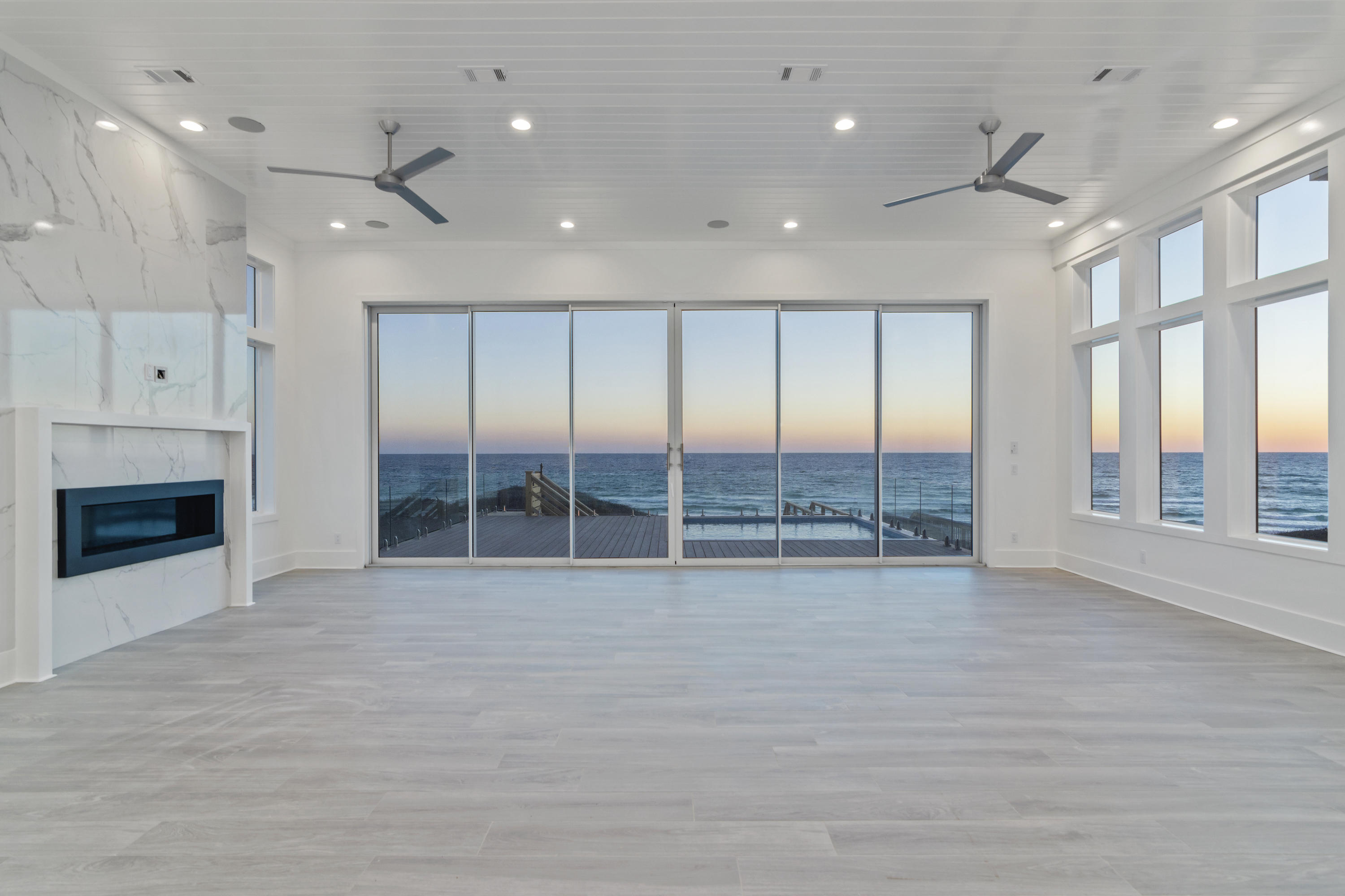 This gorgeous Gulf Front residence located on 30A is a must see!  Designed by Stackable Mracek, and built by Corestruction, this home is truly one of a kind.  An ideal floor plan creates a relaxed flow, while large windows and doors provide an abundance of natural light throughout the main home and carriage house.  The main house features four bedrooms, each with its own bathroom, two large game/bonus rooms, two half bathrooms, a massive main living space complete with open kitchen and dining area, an outdoor living space with ipe wood decking you need to see to believe, laundry on both the first and second level, elevator, and much more.  The carriage house features a full kitchen, open living space, bedroom with ensuite bathroom and laundry.  Below the carriage house is a two car garage with golf cart bay.
