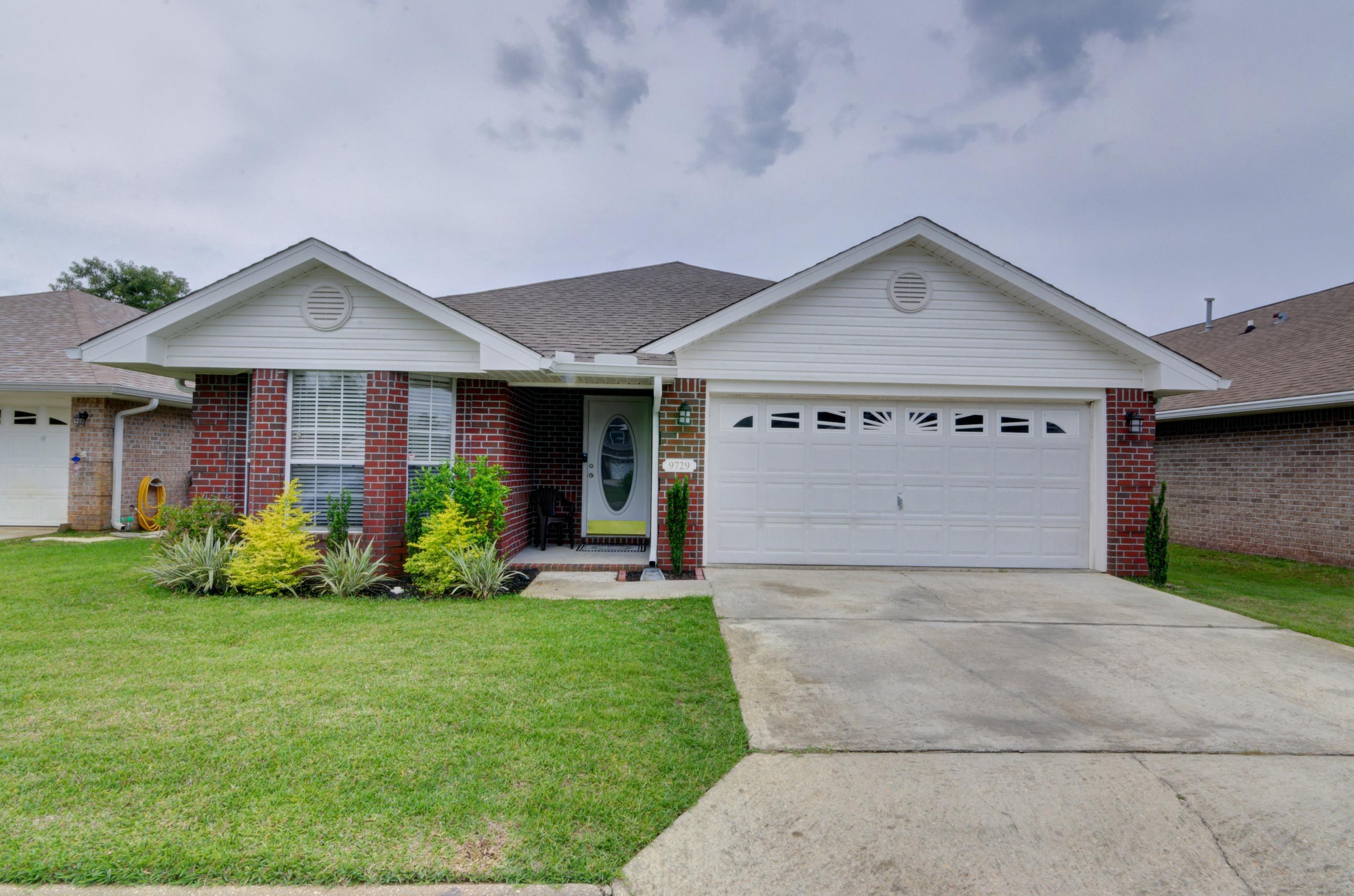 Welcome home to this adorable all brick 3 bed/2bath home located in the popular gated community of Parker's Landing! Enjoy a fantastic east Navarre location close to Hurlburt Field and Navarre's beautiful beaches with a community pool to enjoy! Appreciate tasteful landscaping (maintained by a sprinkler system), a move in ready and impeccable interior, and a fantastic screened in porch to relax on! Inside you'll find hard surface flooring extending through all the common areas, and a split floor plan allowing for master bedroom privacy. The front two bedrooms are nice sized with a shared guest bathroom featuring beautiful tiled floors. The spacious living room has vaulted ceilings and a gas fireplace. The kitchen has stainless appliances and an eat in kitchen space overlooking the backyard. The master bedroom is a fantastic oasis with a large room an en suite featuring double vanities, a combo shower/garden tub, and a large walk in closet. There is an interior laundry room leading to the two car garage, and you don't want to miss the community pool and pavilion!