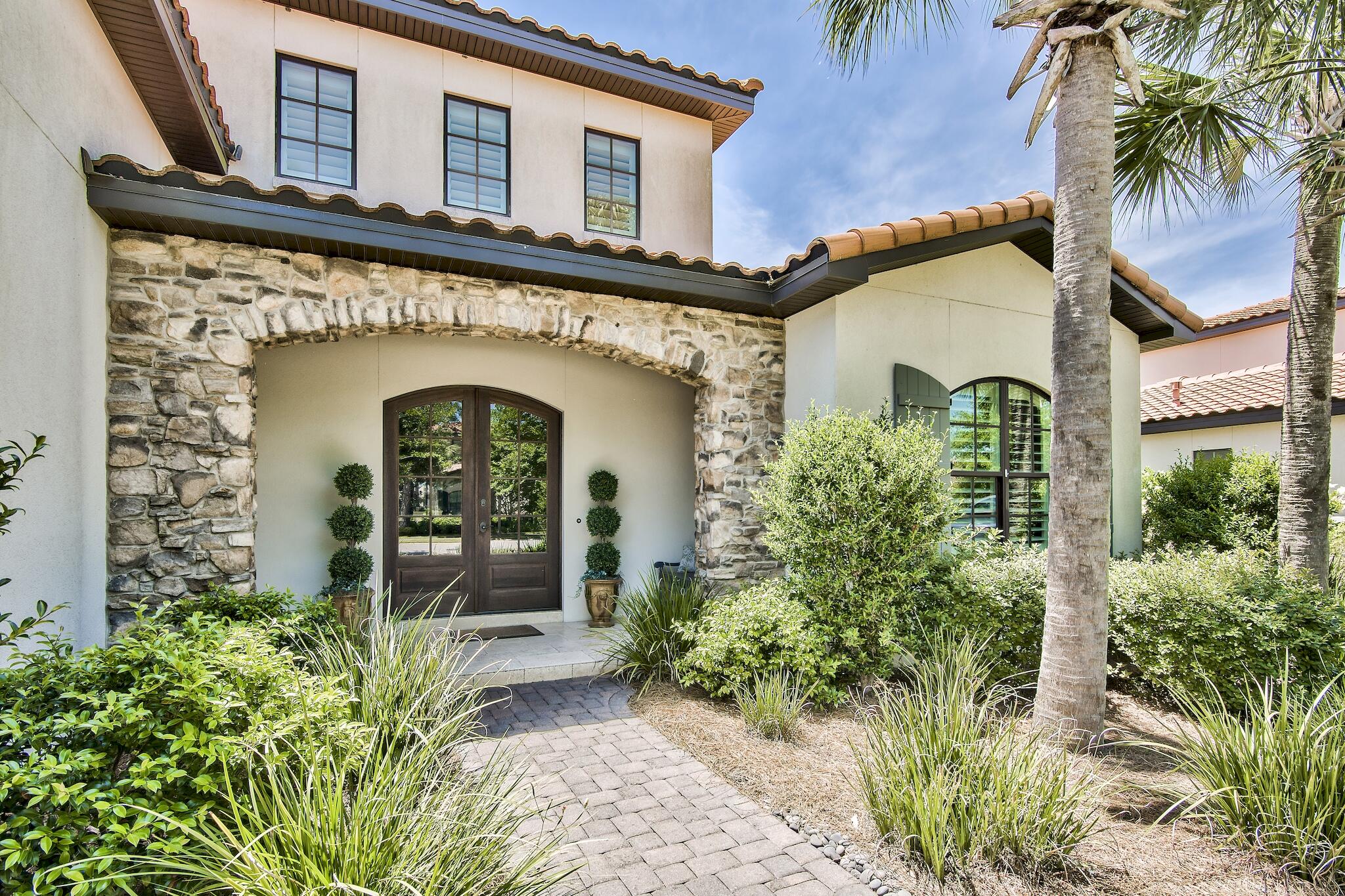 Beautiful, single floor level, open concept home in the highly sought after neighborhood of Genoa in the Sandestin Golf & Beach Resort.  4 bedroom, 4.5 bath built in 2016 with a 2.5 car garage with separate golf cart entrance.  Golf course views and a covered enclosed patio with outdoor kitchen.  Granite counter tops in the kitchen, gas stove, breakfast bar and separate dining area.  Large master suite with large master shower and large walk-in closet.  Hardwood plank floors , raised ceilings, crown molding and coastal feel throughout,  One of the few single level floor plans in Genoa and perfect for primary living or as a second home in this rental restricted neighborhood.