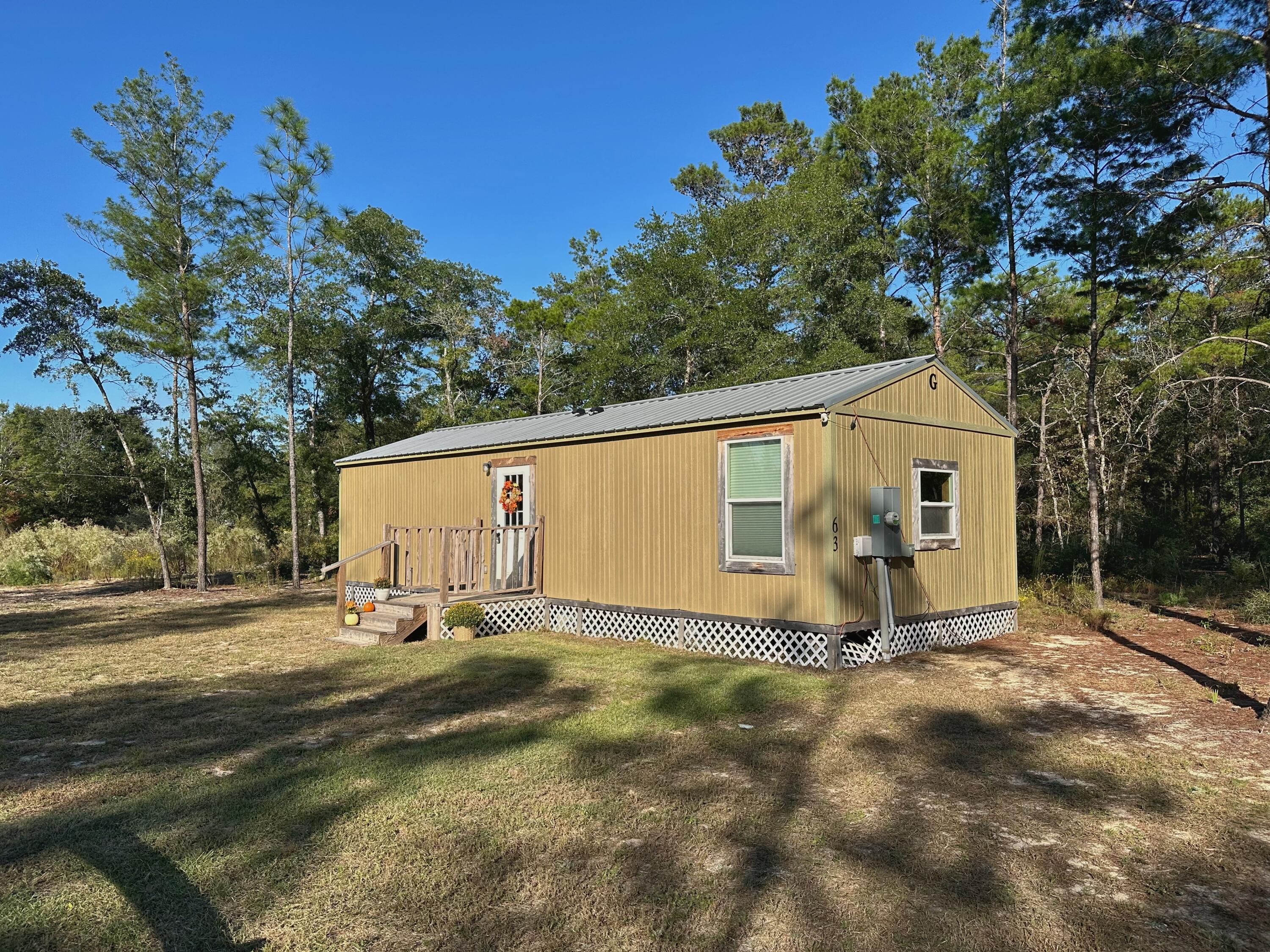 Discover tiny home living at its finest! This charming 1 or 2 bedroom cottage proves that good things do come in small packages. Thoughtfully designed for efficiency and comfort, it features a modern mini-split A/C system, a tankless water heater, and cozy front and back porches perfect for morning coffee or evening sunsets. 

Nestled on a ¼-acre lot, you'll have just enough space for a garden, firepit, or hammock, without the hassle of endless yard work. Enjoy the peace and quiet of country life while being just a quick drive from the powder-white sand beaches of the Emerald Coast. 

Whether you're looking for a smart rental investment, a minimalist retreat, or a starter home that won't break the bank, this tiny treasure checks all the boxes.

Live simply. Live smart. Live small.