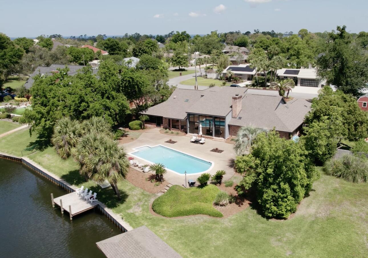 Welcome to 2802 Canal Drive located in the Pretty Bayou Neighborhood of King's Point in Panama City, Florida. 2802 Canal Drive is a unique waterfront home that offers an amazing open concept design and floor plan with 4 Bedrooms, 4 Full Baths, and 1 Powder-room. Interior- The Kitchen is equipped with Quality Appliances from Fisher & Paykel. The Counter-tops & Backsplash are Calacatta Quartz. The Master Suite is water-view and on the main level. Exterior of 2802 Canal Drive offers 140ft of Water-frontage with a newly updated Seawall. This home is perfect for boat lovers- 15 Min. ride to the open pass & 10 min. ride to waterfront dining. Covered boat-slip and floating docks for jetski's + BBQ Pit/Summers Kitchen with Screened-in Patio + 3 Car Garage. all situated on a oversized half acre lot