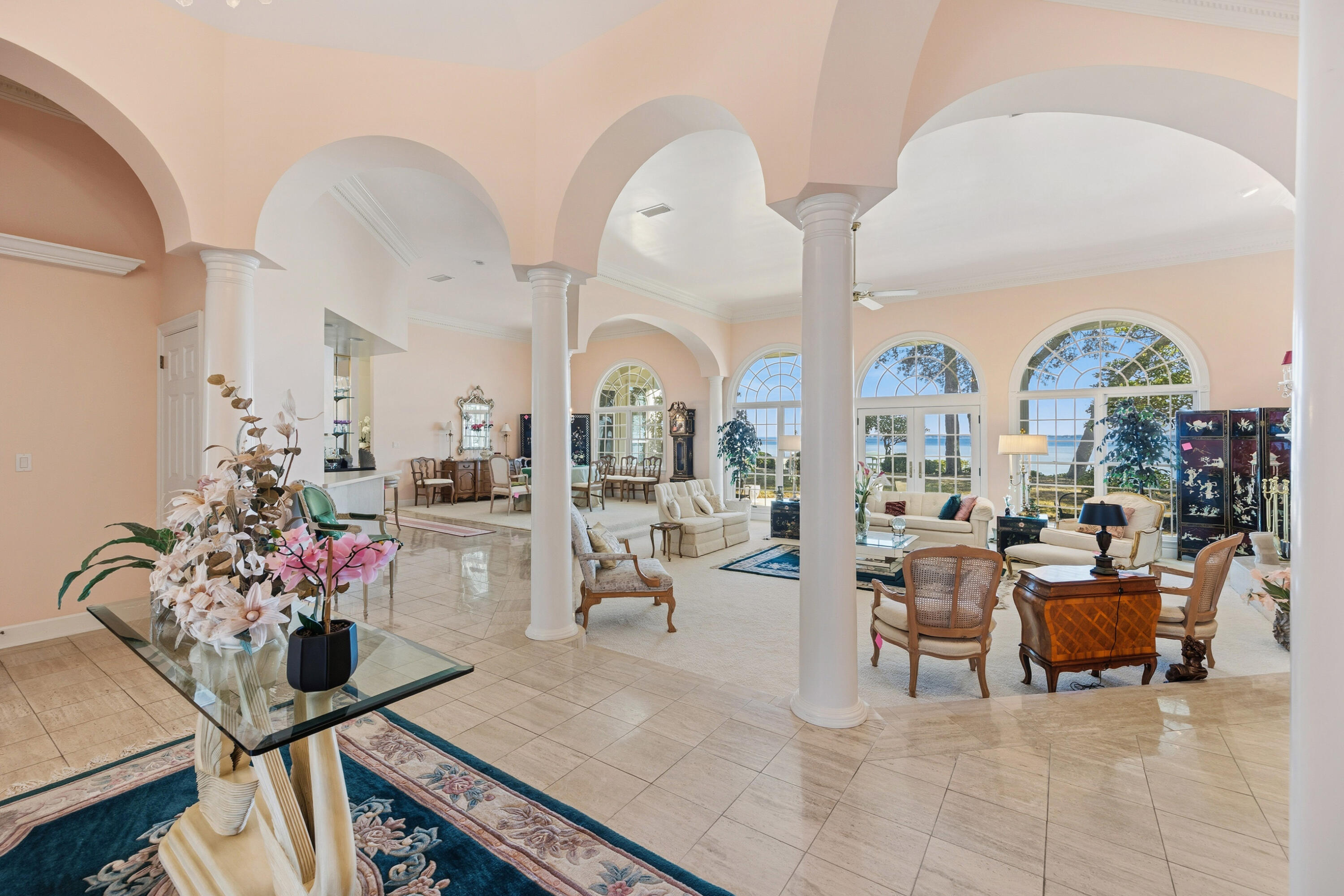 This home makes a statement the moment you walk in.  An open, light-filled foyer with raised ceilings, arches, and columns that create a grand yet welcoming atmosphere, that flows into the main living areas.  A stunning, 3 bed/3 bath waterfront home on nearly ½ acre; with 3 fireplaces throughout the 2 living areas and Master Suite, spacious kitchen, separate formal dining area, wet bar and an office/study that could easily be used as a 4th bedroom.  The Master Suite is like a private retreat, with a sitting area and large windows and doors that walk out to the back patio to take in the incredible water views.  The large, en-suite bath has a soaking tub, separate shower, double vanities and walk-in closet.  The exterior of this home is just as impressive as the interior, with a covered porch and checkered tile floor, a great space for entertaining and taking in the views.  Mature trees and lush landscaping surround the property, providing shade and privacy.  A short walk across the back yard leads you to a private, wood deck overlooking the water, the perfect setting for morning coffee, sunset gatherings, or simply taking in the peaceful surroundings.  A new roof and HVAC were installed 3 years ago and there is a Generac gas generator.  Just minutes from Crab Island and Destin for great restaurants, shopping and entertainment.