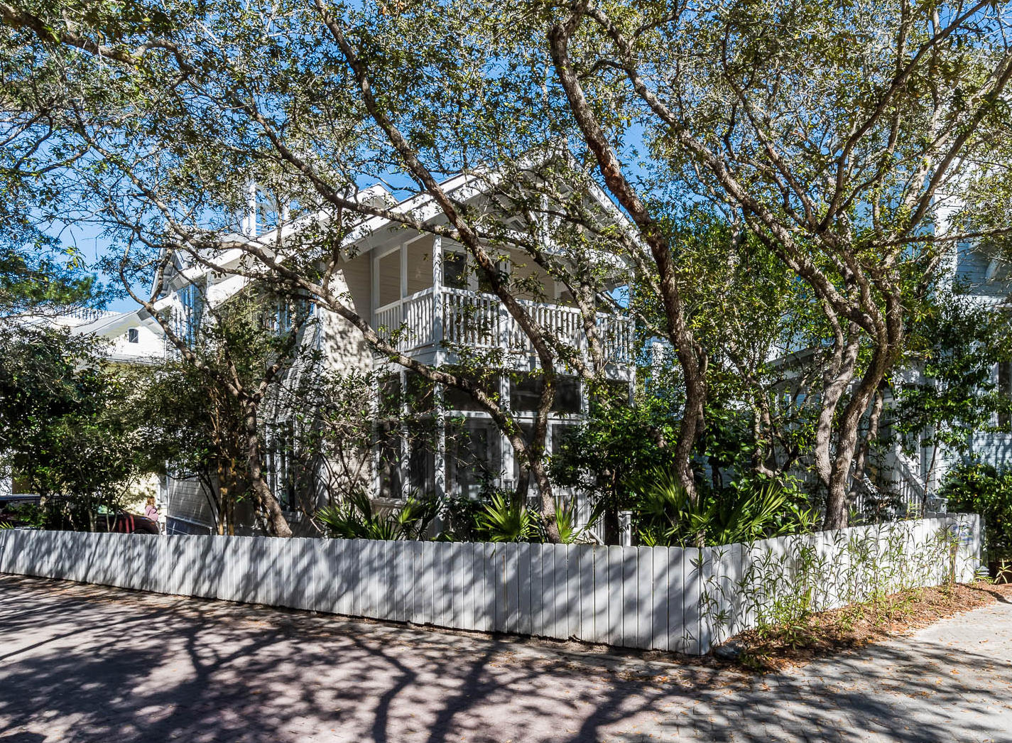 Wave Length sits on the highest point in Seaside shaded behind a garden of live oaks, magnolias and other native vegetation. The home was professionally redesigned and upgraded bottom to top. Wood used throughout on ceilings, walls and floors and painted a crisp white. Custom made linen window shades and drapes allow the light to filter inside. The front living area with custom designed day bed has 2 extra-large twins and serves as a sofa during the day. A wall of book shelves and a perimeter shelf will show off your collection of sea shells. A second living area includes a queen sleeper sofa. The breakfast bar is adjacent to the dining area with under counter ice machine & beverage refrigerator. The custom designed kitchen is a chef's dream: Carrera marble countertops, custom made cabinetry, Sub-Zero stainless and glass front refrigerator/freezer, 36" gas Viking stainless range w/grill, custom designed range hood, Bosch dishwasher, Sharp stainless built-in microwave and the pantry includes laundry. The screen porch off the kitchen serves as additional dining with built-in banquet seating. Full bath with frameless glass shower also on 1st level. The luxurious master suite with king bed includes a private office. The master bath dual vanity is custom made of Carrera marble and features Waterworks fixtures, frameless glass shower with hand glazed subway tile and hexagon Carrera tile floor. The guest suite with king bed and queen sleeper sofa has a private covered porch overlooking the Tupelo gazebo. Ascend the covered tower for a view of the gulf and the most amazing sunsets. Outdoor shower and private onsite parking with room for a golf cart to scoot about town. A complete detail of features and updates are available. This cottage is move-in ready