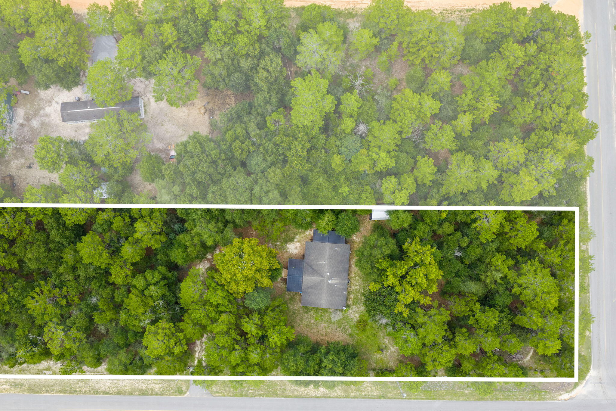 Spacious Property on 6 Lots totaling 1.376 Acres! This 2013 three-bedroom, two-bath mobile home is fully fenced with an automatic gate for privacy and security. A 20' x 12' custom-built front porch, added in 2014, offers storage underneath, while a 19' x 6' side porch built in 2017 features easy access stairs and additional storage—both perfect for relaxing and enjoying the peaceful sounds of nature all around you. Inside, the kitchen is filled with natural light, highlighted by matching appliances and a convenient pantry. A private laundry room includes a washer and dryer for added convenience. The primary suite offers a standing shower and a spacious garden tub for relaxing at the end of the day. Outside is a shed that provides plenty of space for lawn equipment or extra storage. With the flexibility to keep the property as a whole or separate the six lots for individual sale, this home offers both comfort and investment potential.  Buyer should do due diligence in verifying all dimensions and anything else of importance.