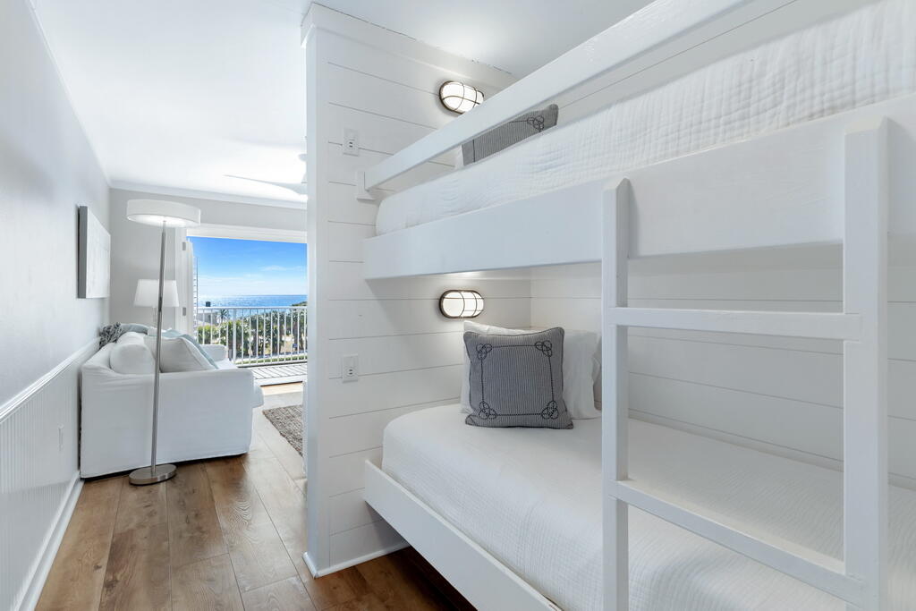 Gulf Place Caribbean unit 414 defines affordable luxury with million dollar finishes and amenities at a sub-million dollar price tag. The views are superb due to this unit being located on the top floor, and it also faces West which makes for immaculate sunsets in the Summer. The amenities (gated beach access, tennis, pickleball, & heated pool) are excellent, and the renovations in this unit are top tier. The location in Gulf Place is also a huge benefit because there's some of the best shopping and dining on 30A within walking distance. Some of my favorites are Shunk Gulleys (best tuna dip in town), Kith + Kin Coffee, Pizza By The Sea (great gluten free options), Perfect Pig, & Renaissance French Restaurant. An underrated benefit of this location is also being directly next to County Highway 393 which makes it easy to avoid traffic along 30A in the busy season.

Unit 414 is outfitted with white oak engineered hardwood flooring, shiplap accents, built-in bunk beds, and a beautifully renovated kitchen. Both bathrooms have also been renovated to include updated fixtures, flooring, and quartz countertops. This unit also has top-tier appliances including a stackable Frigidaire washer and dryer and Energy-Star rated GE stainless steel kitchen appliances.

This property sleeps up to 8 people and offers stellar rental potential. Rental projections of up to $50,000 and rental actuals of $40,000 in 2025 (with owner usage) makes this one of the better cash-on-cash returns along 30A.