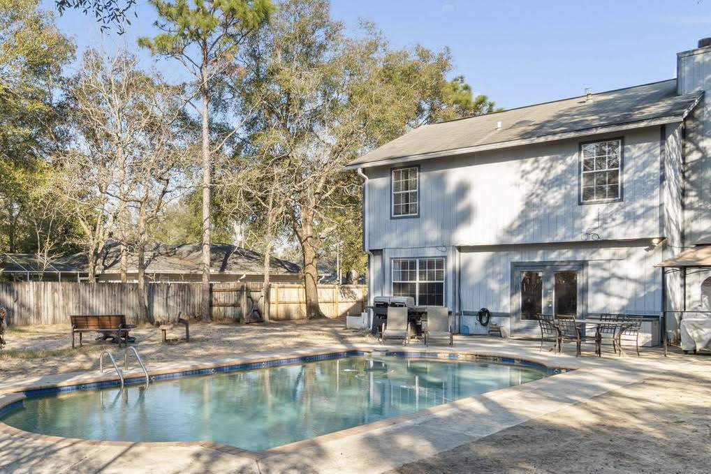 POOL HOME! *New vinyl siding to be installed prior to closing!* Welcome to this perfectly located south Crestview home featuring 3 bedrooms, 2 baths, a spacious loft with an inground gunite pool! Positioned on a cul-de-sac just minutes from hospitals and schools, it's also a convenient drive to Eglin AFB and Hurlburt Field. Inside the front door is an entry way that leads to a freshly painted interior with a soaring two story cathedral ceiling leading to new laminate (with spill repel) flooring  extending throughout the dining room and living room. The kitchen is well appointed with stainless steel appliances (check out that awesome smart touch screen refrigerator!), pantry, and an eat in kitchen space. Past the open concept dining room you'll (MORE) step down into the nice sized living room featuring a wood burning fireplace. Sliding glass doors from the living room lead outside where you'll find a fantastic backyard oasis - a huge fenced in space with an in ground gunite pool, plenty of room to grill out and entertain, and a storage building. The master bedroom is located downstairs with an en suite bathroom featuring a walk in closet with an organizational system professionally installed by Closets by Design, as well as double vanities. Upstairs you'll find a great loft space perfect for an office, playroom, or game room as well as two nice sized bedrooms and a second bathroom with updated flooring. The two car garage has been additionally insulated. Don't miss out on this perfectly located pool home!