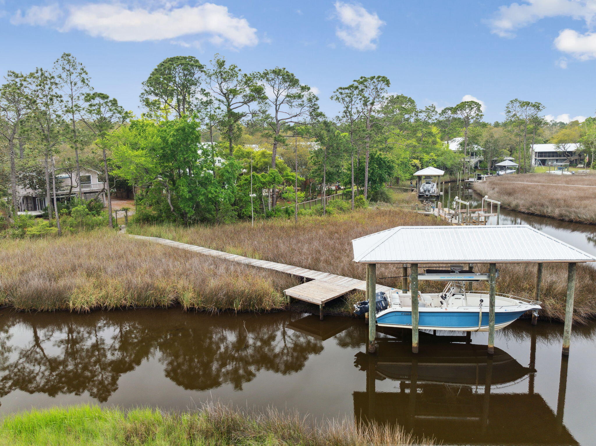 This rare .7-acre lot offers a generous 88 feet of serene canal frontage, complete with a private boat dock and slip—perfect for boating enthusiasts and waterfront dreamers alike. Nestled in a quiet, established neighborhood, this property is a blank canvas for your custom home vision, with plenty of room for expansive outdoor living spaces, a pool, or whatever your coastal lifestyle calls for. Enjoy direct water access and the peaceful backdrop of nature, all while being conveniently close to local shops, restaurants, and beautiful beaches. Whether you're building your forever home or a weekend getaway, this is a waterfront opportunity you won't want to miss.
