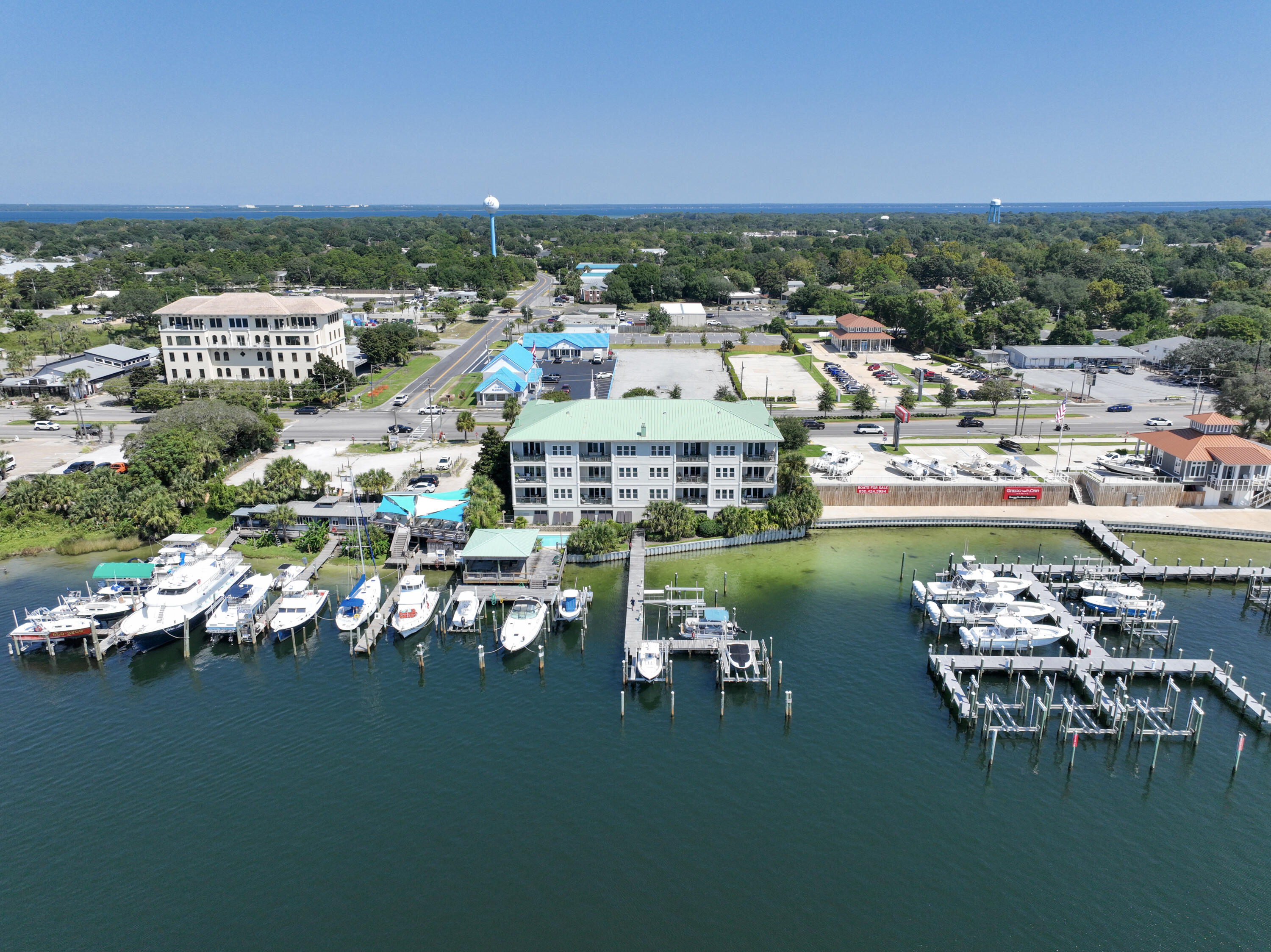 Discover coastal elegance in this stunning harbor-front condo offering an unmatched blend of comfort, convenience and breathtaking views. Perfectly positioned in the heart of Destin, this non-rental property is your private oasis, delivering panoramic sunsets and fireworks from your very own balcony. Step inside to find plantation shutters throughout and blackout shades that create a serene, stylish environment. The open concept living area is ideal for entertaining, featuring a sleek wet bar, perfect for evening cocktails or hosting guests. This condo boasts high-end updates, including a 2-year old A/C system, new washer, dryer, and an O3 Pure Professional Ozone Eco Laundry Washer System and a Stielbel Eltron tankless water heater for endless hot water. Smart living is at your fingertips with an EcoBee smart thermostat and a Ring camera and alarm system, giving you comfort and security wherever you are. Convenient water transportation is available to harbor front restaurants aboard the Destin Water Taxi. This residence also includes: Private boat slip (Boat slip C) with a 3-year old lift, Owner's closet in garage for secure personal storage, one parking space and presenting 10ft ceilings throughout the unit. Whether you're unwinding on the balcony or heading out for an evening cruise from you private slip, this harbor-front gem offers the best of coastal living with all the right upgrades. Schedule your private showing today and experience the sunset views and unbeatable location for yourself. See list of items that do not convey in document section.