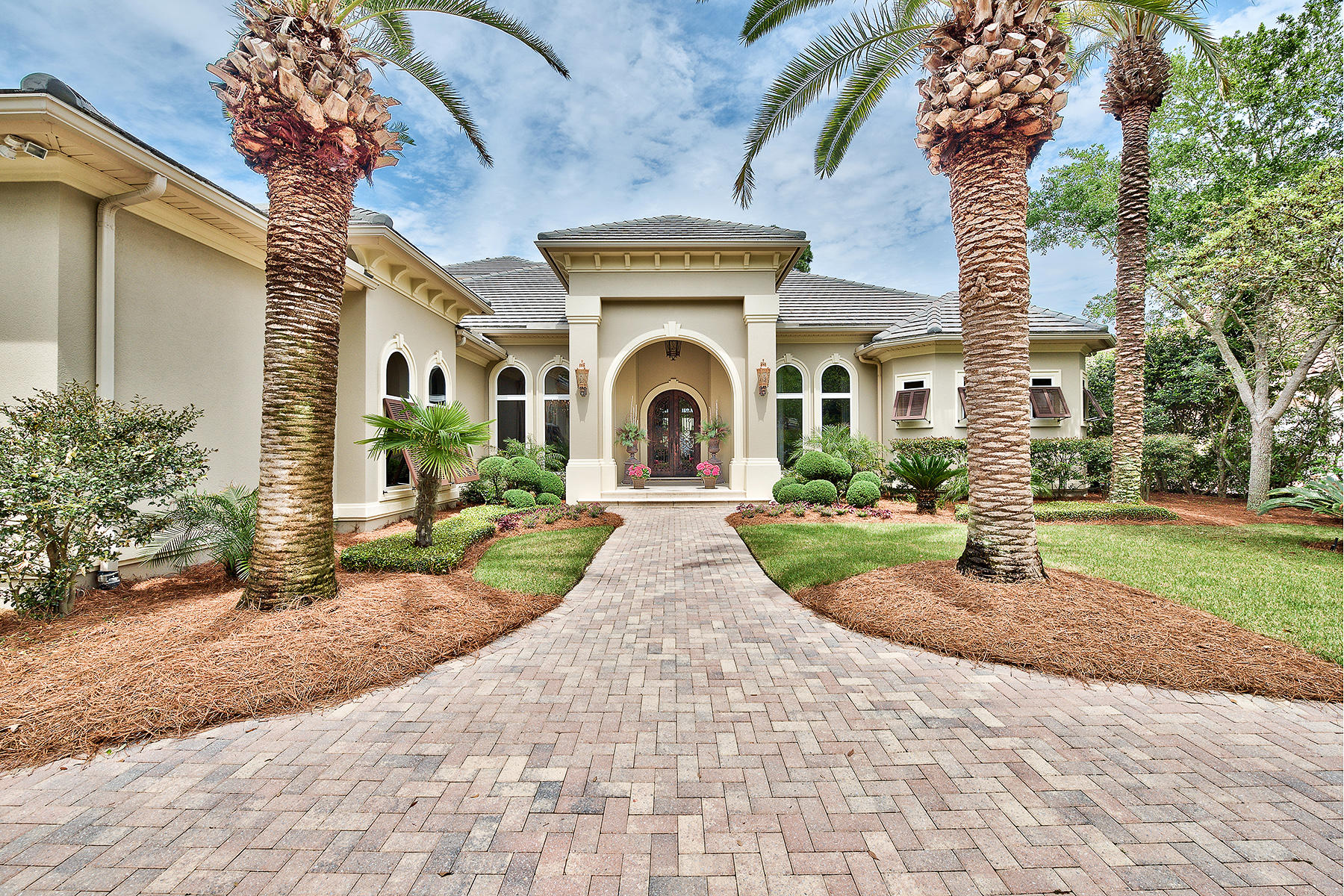 Beautifully situated along the immaculate manicured 5th hole of the prestigious Burnt Pine Golf Club with peaceful lake views, this captivating 4 bedroom, 4 bath Boswell built estate is a stylish balance of formality and comfort. A home created for entertaining, its dramatic public rooms open onto a grand covered outdoor living area with stunning wood ceiling, screened lanai and elegant infinity edge pool. The outdoor kitchen features fireplace, built-in TV cabinet, kegerator and ample seating space - perfect for lazy afternoons or hosting a BBQ. Inside, this glamorous home brims with one of a kind artisan touches with high ceilings, wide hallways and exquisite details with purity of materials and super refined finishes. The designer kitchen with granite slab counter tops, custom cabinetry and bar seating with attached built in table is ideal for informal dining. For more formal gatherings , the st ately living room with soaring ceilings, dramatic windows suffused with sunlight as well as the private, opulent dining room adorned with decorative features will impress your guests. The spacious split floor plan separates the first floor guest rooms from the elegant master bedroom which includes a private sitting area with fireplace, as well as a spa like master bathroom with dual sinks, soaking tub and a must see stone-clad walk through shower. The second level has large home theater with true bar, additional guest room and deep covered porch offering gorgeous lake views. This residence also boasts a dedicated home office, park like grounds with mature landscaping, irrigation system equipped with salt infiltration as well as a heated and cooled 3 car garage with checkerboard floor.
No detail has been overlooked in this true architectural masterpiece of unparalleled elegance.