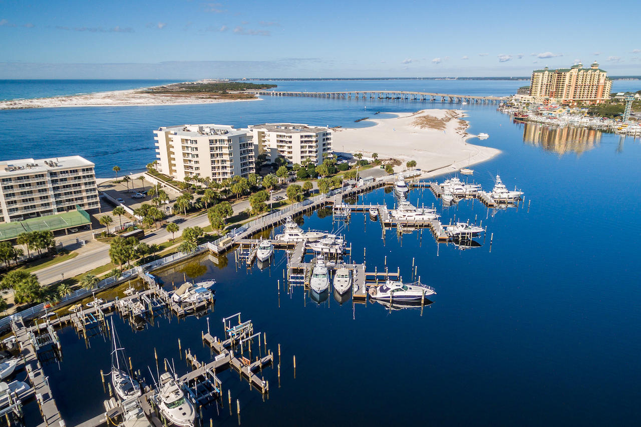 DEEP-WATER BOAT SLIP included! Beautiful fifth floor condominium with unparalleled views of Destin's jetties and East Pass with a boat slip on the scenic Destin Harbor! Floor-to-ceiling windows and a covered balcony run the entire length of the open living/dining/sitting room. A large pass through area to the kitchen and the wet bar in the living area make it an excellent setting for entertaining. The kitchen features an island, large pantry closet, lots of cabinets, and a brand-new stainless refrigerator. The split bedroom floorplan includes a bedroom with ensuite bath and dual sinks on each end, plus a smaller bedroom (or office/playroom/project room) and nearby bath. East Pass Towers II is a gated community on the western end of Holiday Isle which offers a private... beach area, pool/spa and fitness room. The private marina, which was entirely rebuilt in 2017, enjoys the quickest access to the Gulf of Mexico on Destin Harbor. The boat slip includes a boat lift.  Buyer must verify all specifications and information.