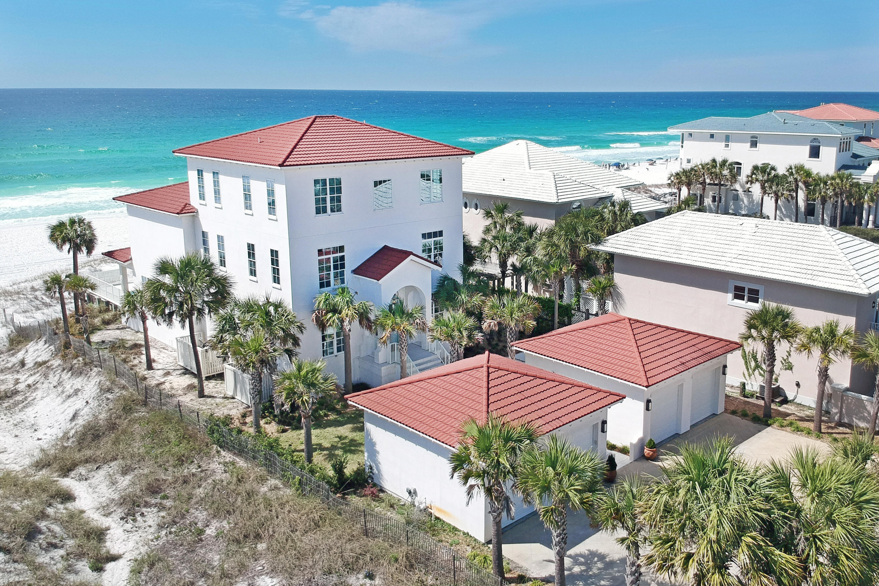This luxurious beach front home sits on almost 1/2 an acre of land, with 4 large garage spaces and ample driveway parking for guests. Peacock pavers guide you through the walkway up to the entrance. The home is finished with coastal chic decor & expansive main floor features a foyer with elevator, storage, guest bath, dining areas, two living areas, pass-through fireplace and all with panoramic views of the Gulf of Mexico. White sandy beaches are directly off the Gulf-side pool deck, shower & covered patio. There is a spacious gourmet kitchen, large center island & bar seating, equipped with stainless steel appliances, granite counters, double ovens, ice maker, and a gas-range. The laundry room is off the kitchen with washer, dryer, utlilty sink and pantry area with a second refrigerator. The second level has 2 Gulf side master suites with covered balcony, two guest bedrooms & a TV/Living room with wet-bar. The third level contains the remaining bedrooms, plus an amazing bonus room with built in beds directly  overlooking the Gulf!  This is one home you must see! Buyer to verify any information deemed necessary & important.