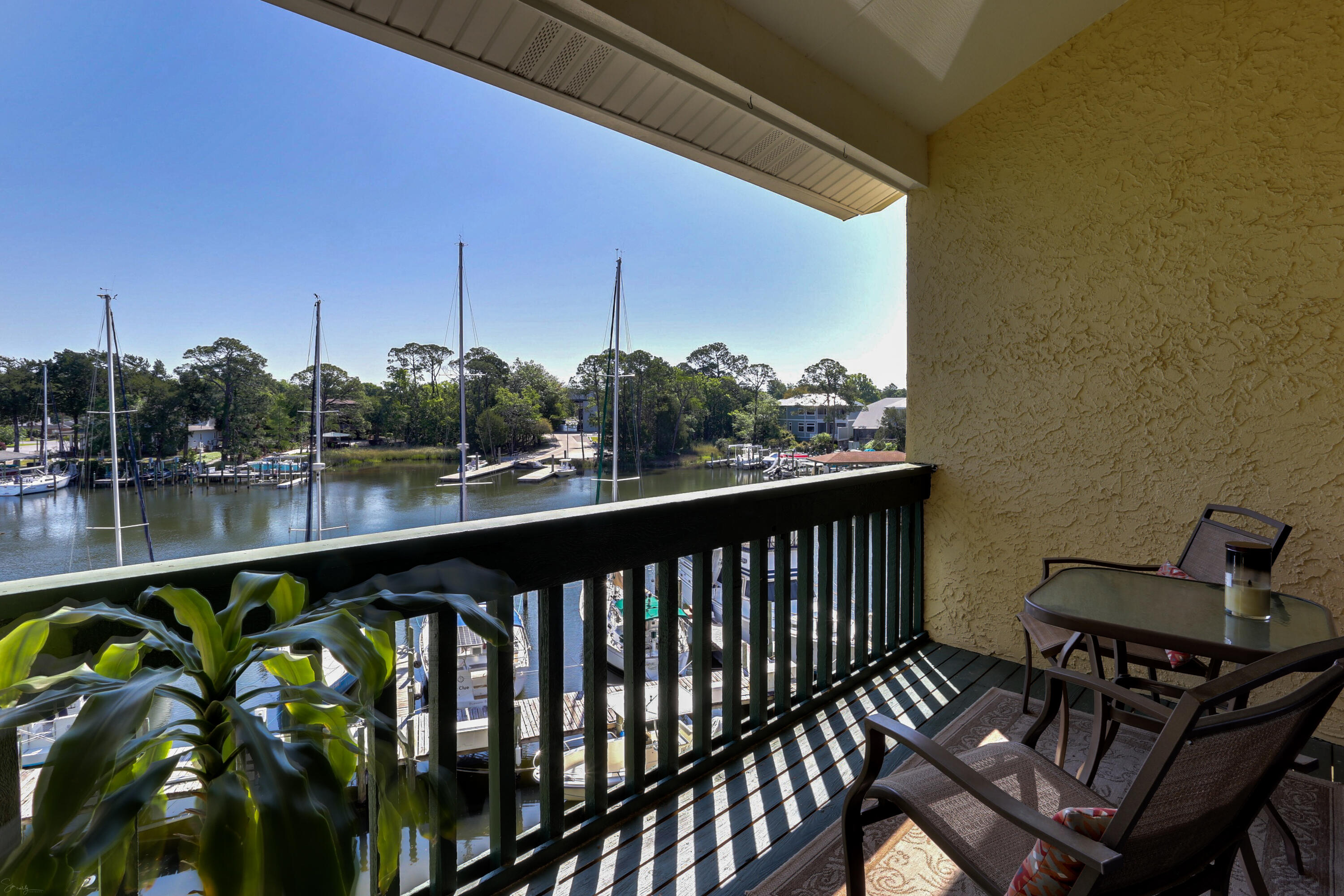 Immaculate waterfront 3 bedroom, 2 bathroom condo available in the desirable Bluewater Bay neighborhood. The primary unit features 2 bedrooms, a full bathroom, washer/dryer, walk-in-closet, full kitchen with large breakfast bar, spacious living and dining room, loft space and screened-in balcony. The secondary unit is a studio with a full bathroom, kitchenette with small bar, and large private balcony. The secondary unit is being sold fully furnished: immediately ready to rent out as an income property! Roof was replaced in 2018-2019, new AC unit in the secondary unit 2019, updated loft railing in the primary unit 2020, renovated bathroom and kitchen floor in the primary unit 2021, and freshly painted throughout. Both units have beautiful water views overlooking Bluewater Bay Marina are are conveniently located to Bluewater Bay pool, tennis center, and golf courses.