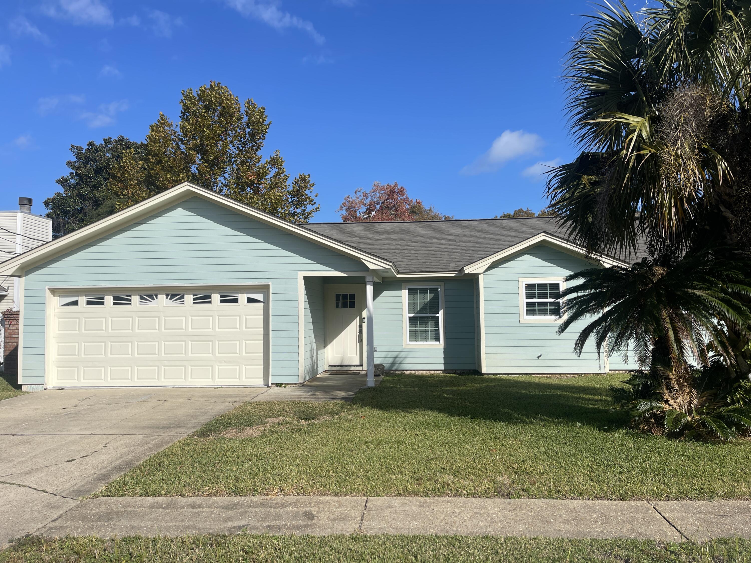 Beautifully renovated, 3 bedroom, 2 bath home in the heart of Destin, just minutes from beaches, shopping, restaurants, and all of the entertainment in town! This lovely home features a split, open floorplan with upgraded lighting, plank tile flooring, and neutral paint throughout. The spacious living room boasts a fireplace and double doors leading out to the big back yard, which has an open patio with a pergola and is fully privacy-fenced for peaceful enjoyment. The gorgeous kitchen is complete with an island/breakfast bar, granite counter tops and plenty of cabinet space, stainless appliances (including a smooth cooktop stove), beautiful backsplash, and formal dining area. The primary bedroom is nicely sized and has its own en suite with a tiled, walk-in shower. The two guest rooms are  on the other side of the home for privacy, and they share a full guest bath. There is also a 2-car garage with laundry hookups inside. Pets may be considered on a case-by-case basis with prior owner approval and a non-refundable pet fee. No smoking, including vapes.