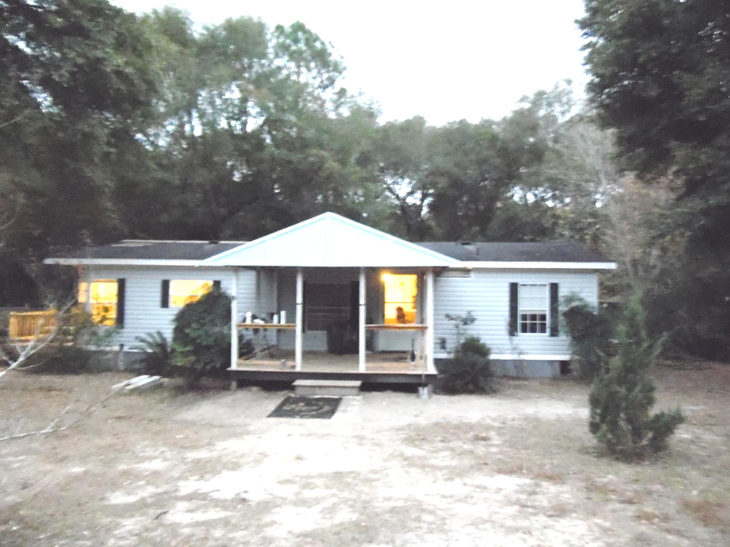 Locate near some of the best fishing in North Walton County. You are within a 1/2 of a mile of public launch for Lake Juniper. Enjoy living in this 1994 ''Grand Manor'' manufactured home 1292 square foot home with 3 bedrooms and 2 baths. Surrounded by large shade trees. Would make a great ''home-base'' for those with a travel trailer that needs a place to call home! Spacious living room and formal dining area. Kitchen features eat-in area, lots of cabinets and counter space, large pantry, with adjoining laundry area. Master bedroom with walk-in closet. Master bath has large garden tub with separate shower. Large covered front porch with new decking, new hot water heater, 2 new window a/c. Back yard features pole barn/storage area and fenced on three sides. City water & septic.