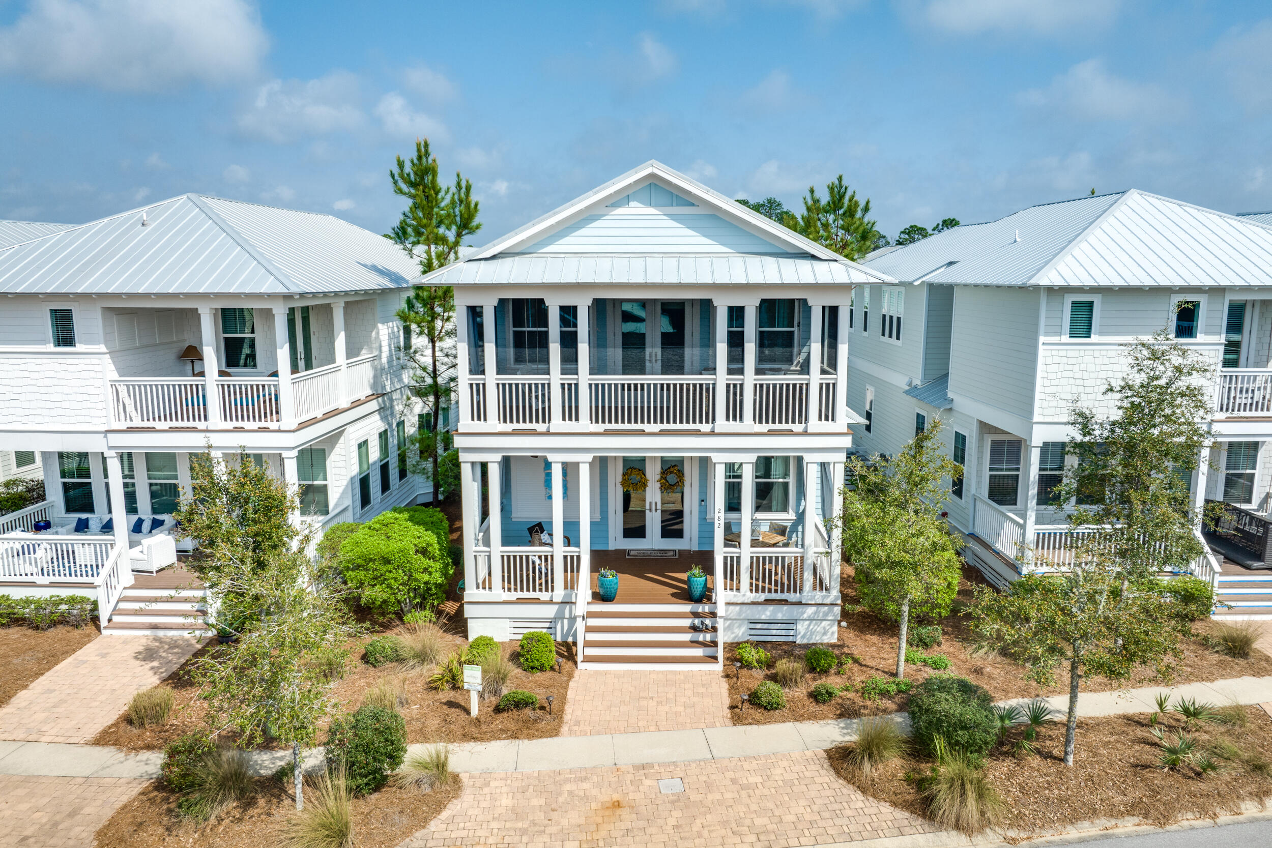 Welcome to your own piece of paradise in Seagrove Beach, Florida! This beautifully furnished beach house is the perfect getaway for families and groups of friends, with plenty of space for everyone to relax and enjoy the sunshine. With a 2-car garage, you'll have plenty of space to park your vehicles, as well as store your beach gear and bikes.
As you enter the home, you'll be greeted by an inviting living room with comfortable seating and a large flat-screen TV. The open concept floor plan flows into a well-equipped kitchen with stainless steel appliances, marble countertops, and a breakfast bar. You can gather around the large dining table with seating for family meals or game nights. On the first floor, you'll find a spacious bedroom with a king-sized bed and a private bathroom. This is a great option for anyone who prefers not to climb stairs. The second floor offers three more bedrooms, including a bunk room with two twin-over-twin bunk beds, perfect for kids or teenagers. There is also an additional guest bedroom with shared bath, and another primary suite with huge closet and private bath. 
The big porches on both levels offer stunning views of the surrounding peaceful  area. Enjoy a morning coffee or an evening cocktail while taking in the beautiful scenery. The outdoor shower with upgraded enclosure is perfect for rinsing off the sand after a day at the beach.
This beach house is also equipped with spray foam insulation in the attic (one of the few homes in the community with this feature), which ensures comfortable temperatures throughout the year and energy efficiency. The house is nicely furnished with coastal décor and all the modern amenities you expect..
Located in a quiet neighborhood, this home is just a short walk or bike ride away from the charming shops and restaurants of Seaside.
Only a short bicycle ride away, you'll find yourself enjoying downtown WaterColor, Seaside, and the gorgeous Gulf Coast beaches! NatureWalk at Seagrove is nestled between protected borders of the state forest and only minutes from 30A. Community beach trail makes the sugar sand beaches just a 5 min bike ride away. Amenities include outdoor fitness stations, sports court, swings, playground and the Gathering Place with 2 pools (one is a heated lap pool), kiddie pool, grills, firepit, and big bar area for parties!