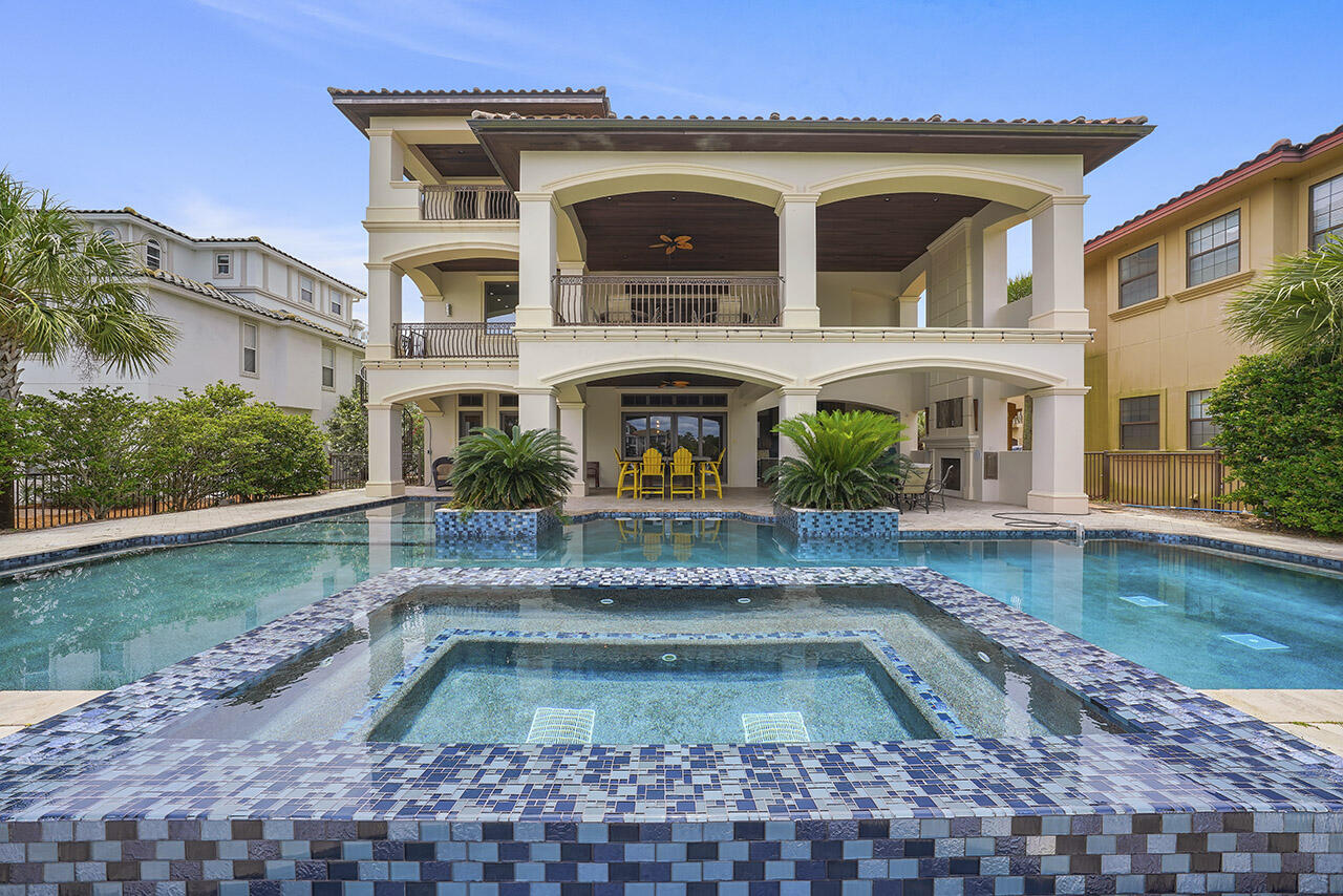 THE BEST IS YET TO COME with this Amazing Executive home situated on 78 ft. of lake frontage with tranquil lake views, and gorgeous Gulf views from the south-facing front of the home.  Every level of this three-story coastal beauty is perfectly planned to maximize relaxation, privacy, and enjoyment!  There are multiple terraces for viewing, dining or just kicking back to read a book, including a rooftop deck to enjoy the breathtaking sunrise and sunset views.  Located just steps away from the famous Gulf of Mexico white sandy beaches in the Crystal Beach area, and a short walk to the Crab Trap.  This well-designed floor plan offers 7 spacious bedrooms with en suite baths, 3 bunk rooms (total of 8 bunks) and a total of 8.5 baths.  Home will sleep 28 people.  The main gathering area is the  floor with open-concept kitchen/dining and living area. Comfortably entertain all your guests in this grand dining area with pecky cypress ceiling and newly added crystal chandeliers or let the party overflow to the deck overlooking a large resort style pool and lake. Pool was completely resurfaced in 2021. All new mosaic tiles installed in the pool and hot tub.  Enjoy the outdoor kitchen and fireplace with flat screen above for those ballgame parties...all under roof. Two bedrooms, bunk rooms, laundry, and game room with kitchenette on ground floor level.  Just off the entry way there is a 2- stop elevator. Home solidly constructed in 2012 with quality materials, including impact windows and doors.  This is a home you will want to keep in the family for generations to enjoy.  Investors will want this one in their real estate portfolio for good reason...strong rental income!