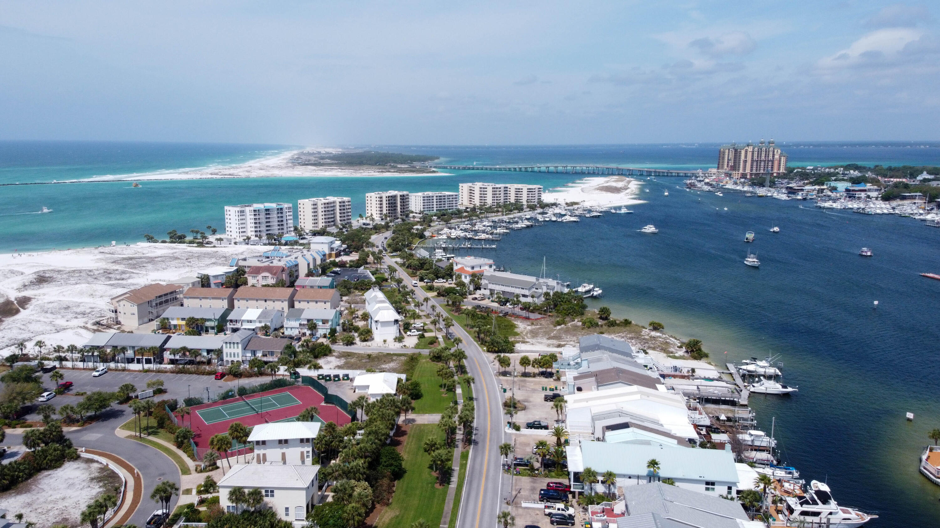 Canal Place Phase II is centrally located on Holiday Isle, it's approximately a 10 minute walk to Private beach access and Norriego Point Park with tide pools and a marina.  Unit 201 is the perfect beach cottage for a full-time residence, second home or vacation rental. This condo was updated in 2022 and still has its sparkle.  High Impact Windows and Doors installed in 2024, new roof in 2021.  LOW Association FEES.  Unit being sold fully furnished and rental ready.  Check out the 3D tour.  Rental income in 2025 was around 25k and is exceeding those numbers for 2026, DON'T MISS OUT ON Destin's PEAK SEASON vacation rental income.