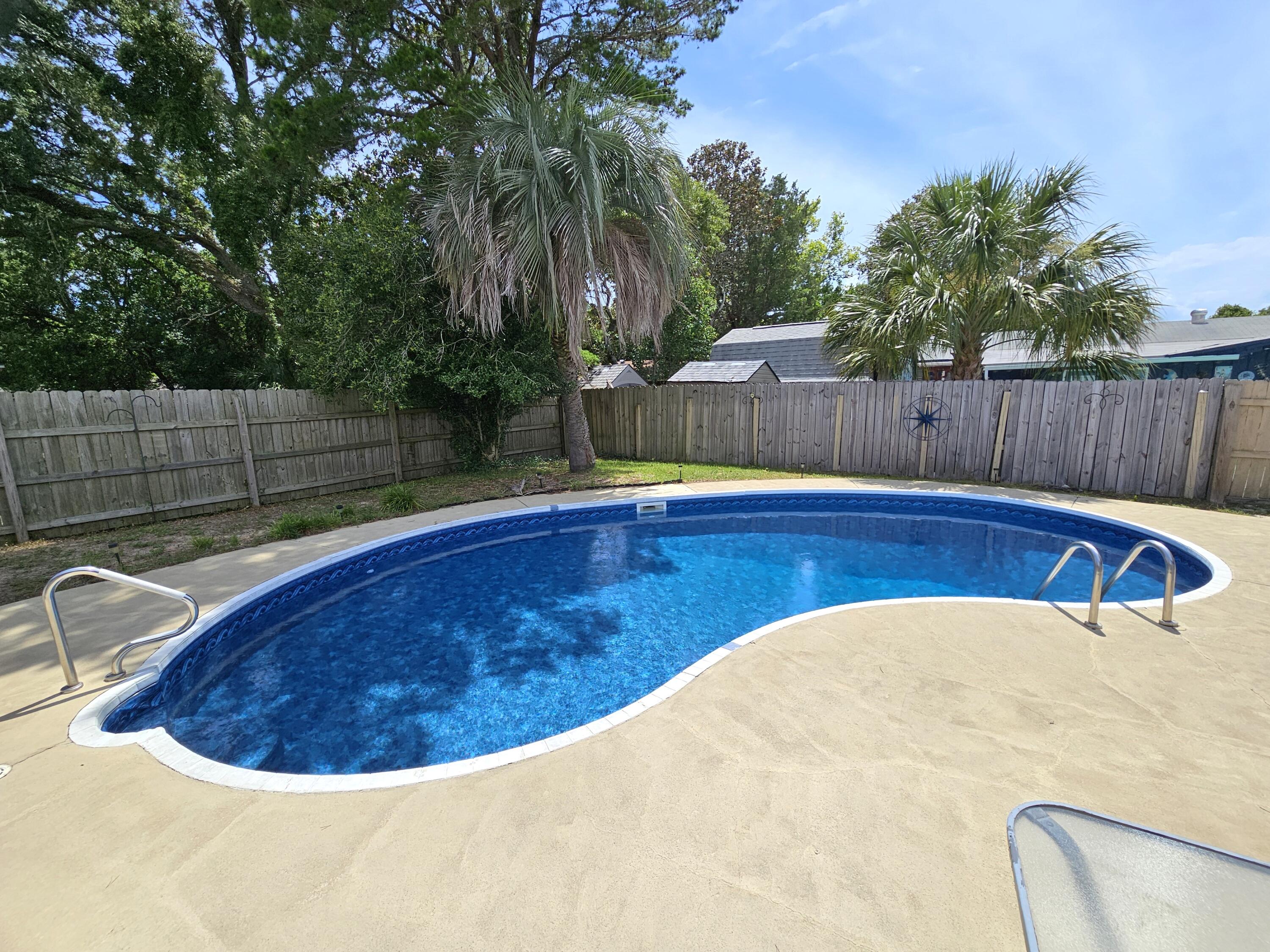 CHECK OUT PRICE IMPROVEMENT! Charming 4-bedroom home with beautiful pool and attached garage in Port Dixie neighborhood. Pool liner was replaced recently, aluminum wiring replaced 2024, roof 2021, water heater 2022 and HVAC 2012.  Low traffic location conveniently close to ballfield right down the road, military bases, shopping, restaurants, entertainment and local waterside parks. Two living areas to relax. The front living area open into the dining area and there is a back den living area with a bonus area overlooking the beautiful pool. The Master Bedroom overlooks the pool as well. Property to be sold As-Is. Buyer to verify all information and measurements.