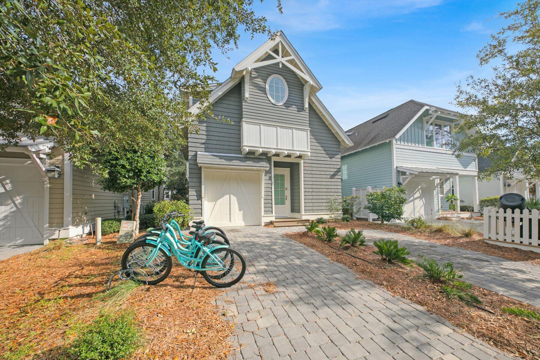This quintessential beach cottage in WaterSound West Beach boasts three beds, four-and-a-half baths and lots of hidden extras. Fully furnished, it's designed to comfortably accommodate 14 guests. Completed in 2020 to a design by R.W. Lowe Architecture, this attractive coastal retreat was built to the highest standards by Ryan Harp Construction. With two primary suites, a bunk area and a fun-filled game arcade on the second floor, it's ideal as a full-time residence or as a vacation home with rental potential. Leave your vehicles on the twin parking pads and head inside. The open floor plan is designed for seamless indoor/outdoor living, whether you're enjoying a peaceful break or entertaining family and friends. Bathed in natural light, the spacious living area has designated areas for cooking, dining and relaxing. Shiplap walls, airy 10-foot ceilings and gorgeous wood flooring enhance this attractive space, all lit by designer lighting. The pristine white kitchen is very much a part of the social space, with an expansive quartz-topped breakfast bar. Five stools invite social conversation over long, cool drinks and tasty snacks. This well-appointed space has ample storage, KitchenAid professional appliances and a generous six-burner stove beneath an oversized hood. Beyond the sitting area, French doors open onto a sunny screened porch. It's a place for relaxing and enjoying the peaceful, sun-dappled views of the preserved woodland. Imagine breakfast outdoors accompanied by the sound of birdsong as you plan the day's activities. Return in the evening for sunset cocktails after rinsing off sandy feet under the outdoor shower. The cottage includes a first-floor master suite for living all on one level, if required. Four built-in bunks make good use of the flex space on the second-floor landing, and there's still room for a comfy sofa and a wall-mounted TV. The adjoining bathroom with artisan tile adds another practical touch. Tucked around the corner, the gaming arcade is sure to be popular with kids of all ages. The second-floor master suite also makes good use of space with a king-sized bed, a reading area and additional space for a desk. Beneath the sloping eaves, the third bedroom is furnished with two queen beds. Another pristine ensuite bathroom provides private facilities for visiting guests. This serene coastal retreat includes a garage which can house your golf cart for getting around. Feel the breeze in your hair as you explore winding boardwalks lined with mature pines, play golf or visit the beautiful beach, all within this exclusive gated community. Residents and guests can also enjoy the heated resort-style community pool with shady cabanas, outdoor grills and a cozy fire pit for toasting s'mores.