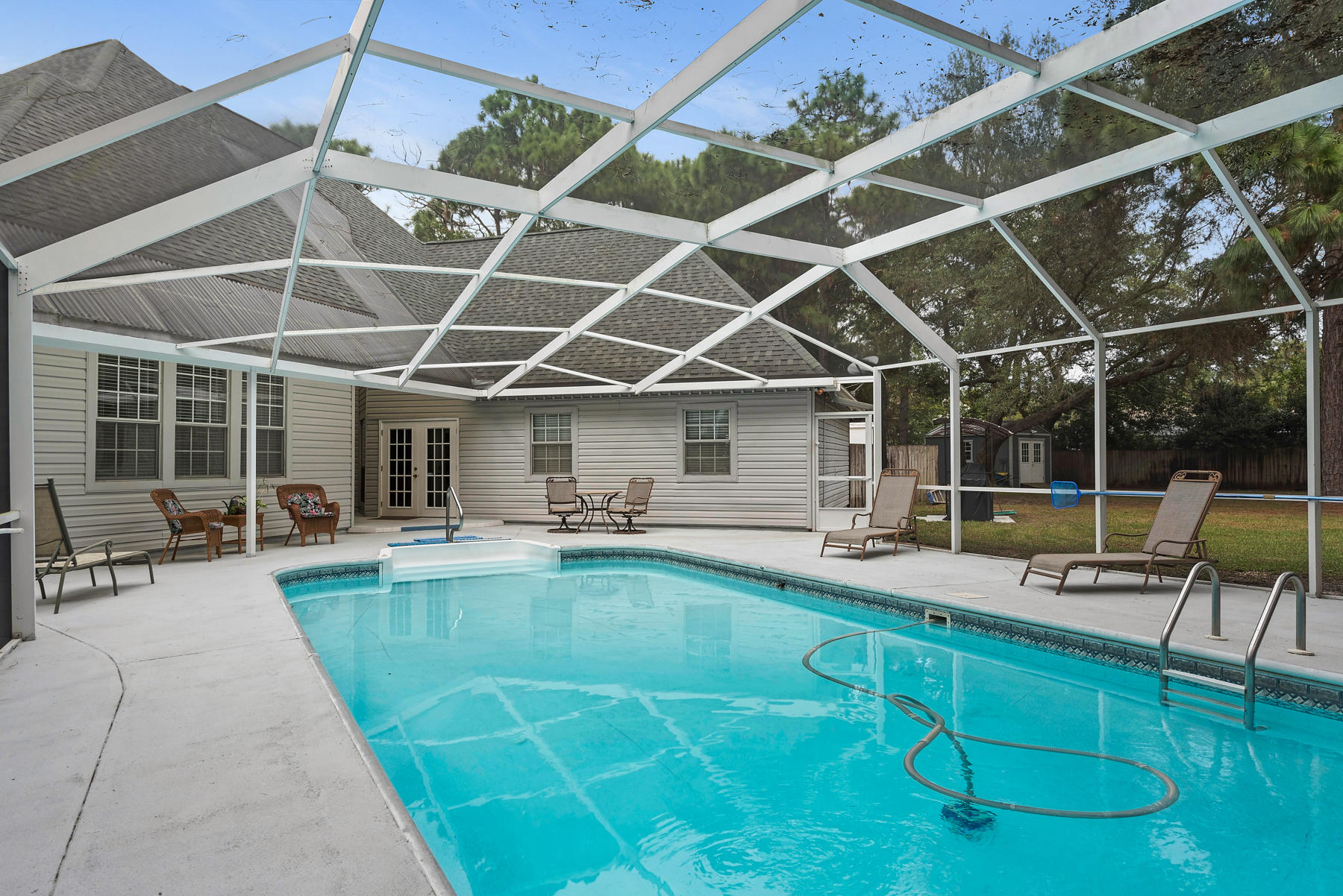 OutstandingMeticulously KeptLarge Family Home with a BIG Inviting Pool & Screened Lanai complimented by an enormous fenced in backyard with mature trees, and an outside storage building.
(Click on the photos and virtual tour) to discover the many upgrades that have been done to the property with gorgeous granite, cabinetry, and designer faucets & sinks in the kitchen and all bathrooms. Experience the comfortable feel of the home as you enter the front door with soaring 18 foot ceilings. Relax in the over sized living room, and retreat to total comfort in the large bedrooms. Enjoy being able to entertain from the incredible kitchen with high end appliances, plenty of pantry space, and a very well placed service bar. Come see it today, buy it, and love it forever!