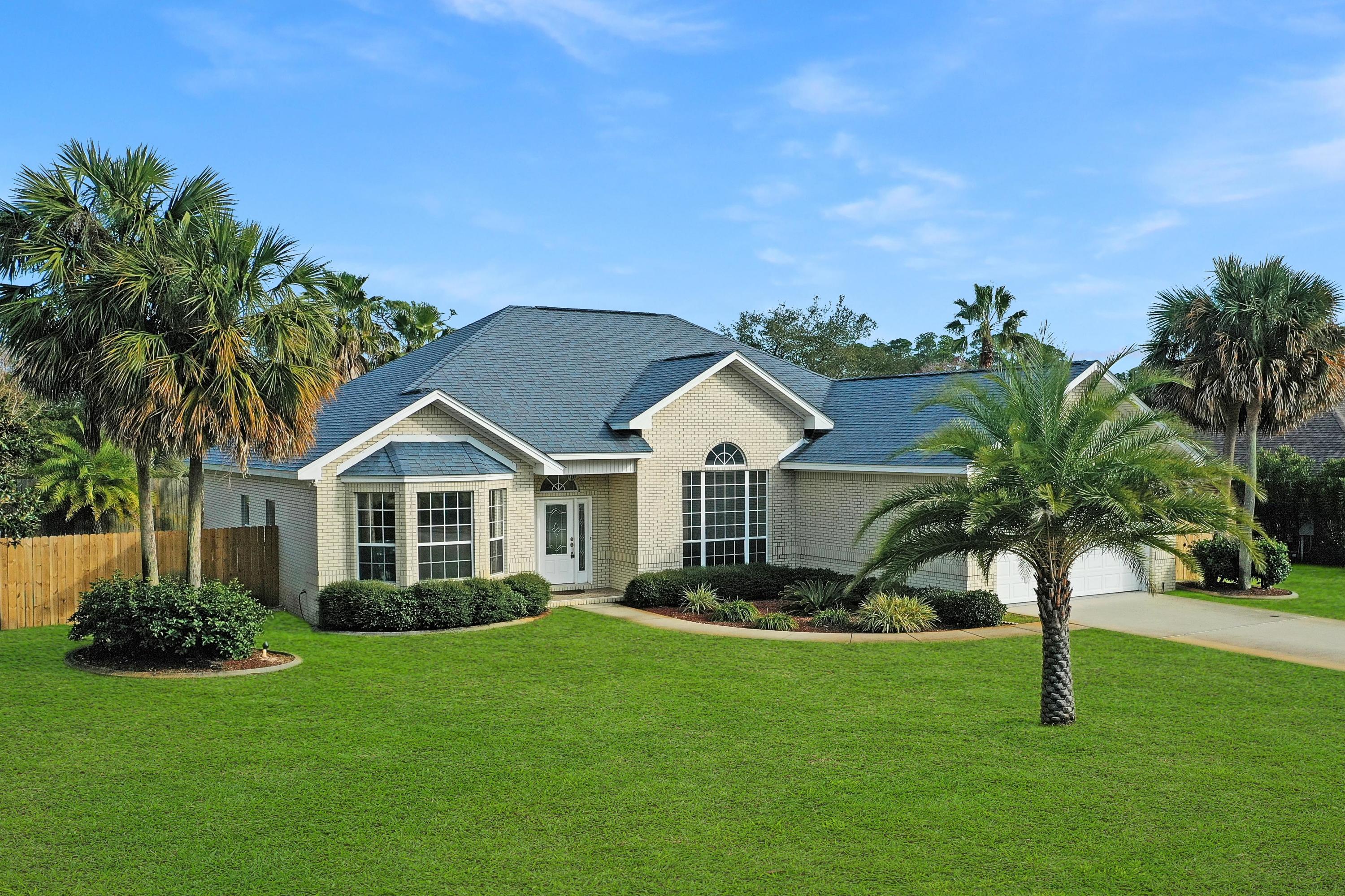 Custom brick and quality built home located in the Elite Waterfront Community of Costa Verde. Only 21 homesites with deeded waterfront access to the sound. Meticulously maintained home is move in ready! Open floor plan with high ceilings and many windows allows the natural light to flow through. 3 bedrooms, 2.5 baths, plus a flex space perfect for your home  office/playroom/game room/4th bedroom. Elevated ceilings with crown molding, electric fireplace and a spacious living room opens out onto a nice size covered tile porch. Very private, fenced backyard is landscaped with plenty of room for entertaining. Kitchen features granite counters, stainless LG appliances, plenty of cabinets, breakfast bar and nook, and a pantry. Master Suite with 2 walk-in-closets, separate vanities, more separate shower, and garden tub. Flex space off the Foyer on the front of house. 2 additional bedrooms are situated on the other side of the house and share a bath. 1/2 bath conveniently located off the laundry room and has easy access from a glass door to the side yard where an outside shower is located.  Plenty of storage places in this home, plus a 2 car garage. Landscaping is easy to maintain w/sprinkler system, well and pump.