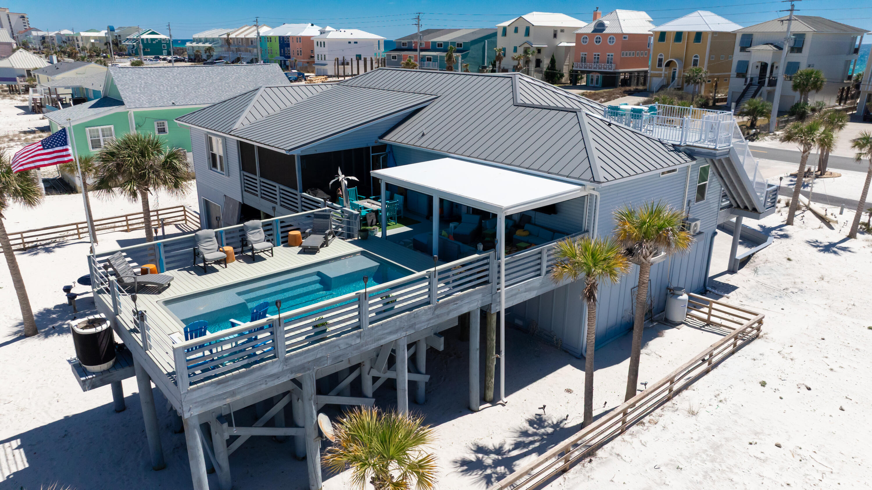This beach homes has it all! Whether you're seeking full-time, vacation escape or investment property, this home is sure to exceed your expectations. Wake up to the sound of waves, spend lazy days by the pool and end with sunset views from the 10 x12 crow's nest. 3 Bed/3 Baths plus a bonus rm  (Sleeps  up to 12) and an office. Living and Den create an inviting space with a gas fireplace and a 4-seat. Main areas flooring is ceramic plank tile. The Kitchen features dual powered range with 2 ovens, stainless appliances, oversized breakfast bar, abundance of Granite Counter space and custom soft close cabinets. The dining area includes a custom