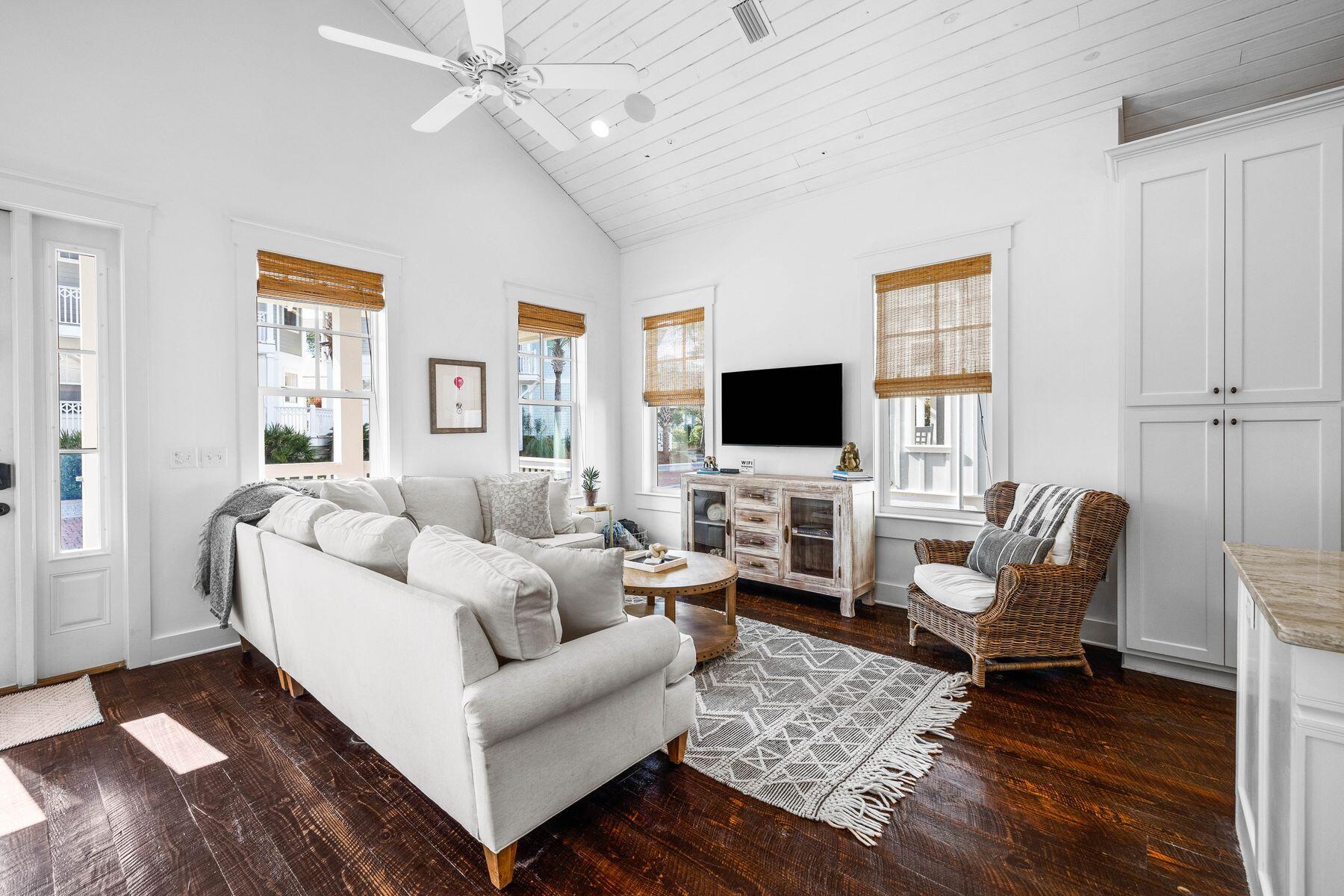 This surprisingly spacious beach cottage is perfect for laid-back luxury living, with shiplap and sliding barn doors adding a rustic touch to the coastal decor. The location could not be better, backing onto mature forest and a walking/bike path leading to Seacrest Beach amenities. The white sandy beach and 12,000-sq.-ft. community pool is conveniently close by, along with 30A shopping and dining. Plus, the home's walkability to the upscale shops, restaurants, and events in Rosemary Beach and Alys Beach means you'll have the best of 30A living right at your doorstep. This beautifully presented turnkey property is freshly painted and fully furnished. You'll feel at home the moment you step onto the front porch.

Dark wood floors and a lofty vaulted ceiling add character,
