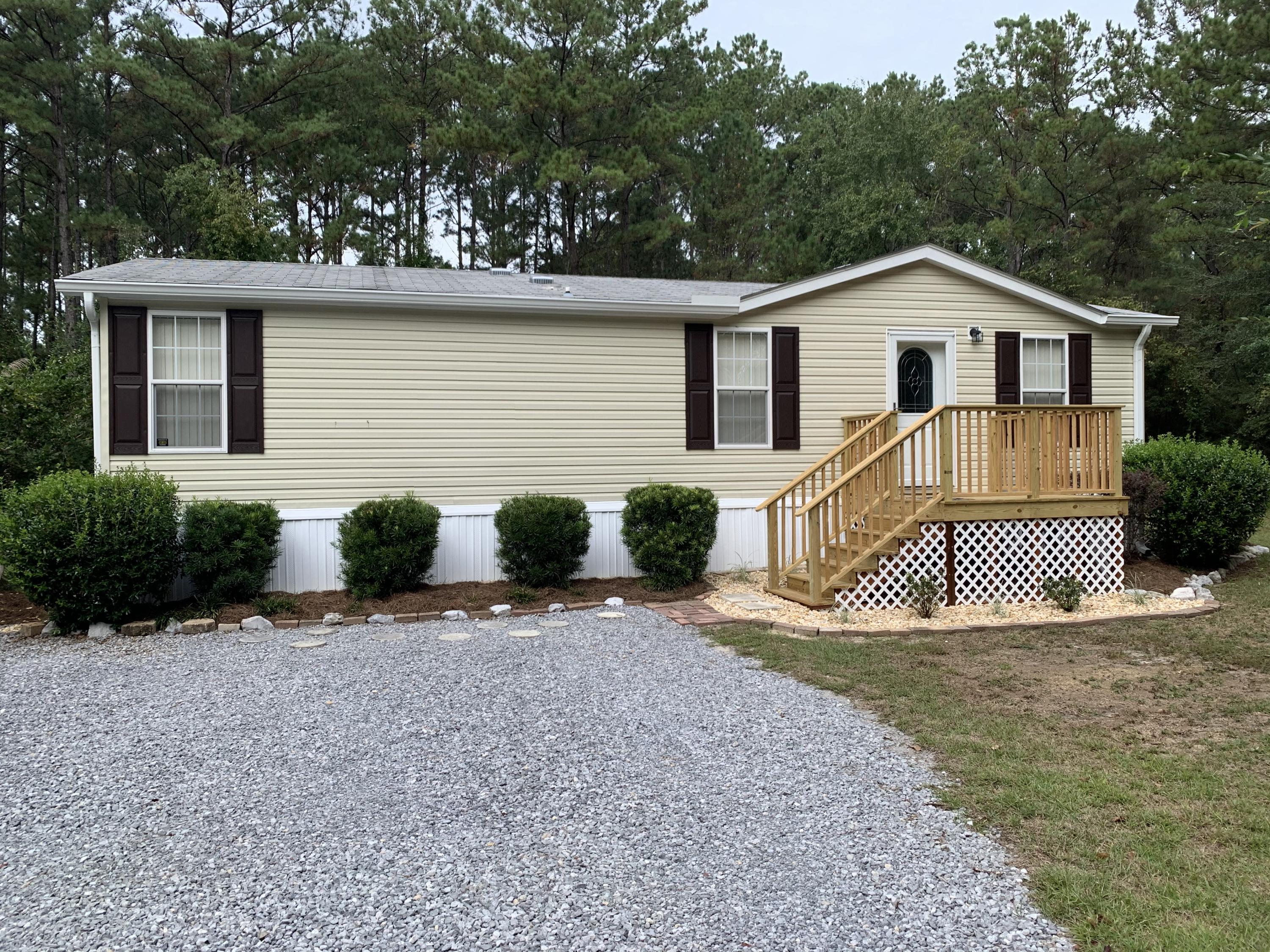 Beautiful manufactured home in immaculate condition with detached single-car garage. Home has laminate floors throughout - easy care & cleaning! Refrigerator, washer & dryer are included. Natural privacy and on an oak tree-lined paved road. Private well with Culligan water system. Large backyard with small storage shed. Single garage has window A/C - could become a bonus area! Boat launches & parks are close by for fishing, swimming & boating.