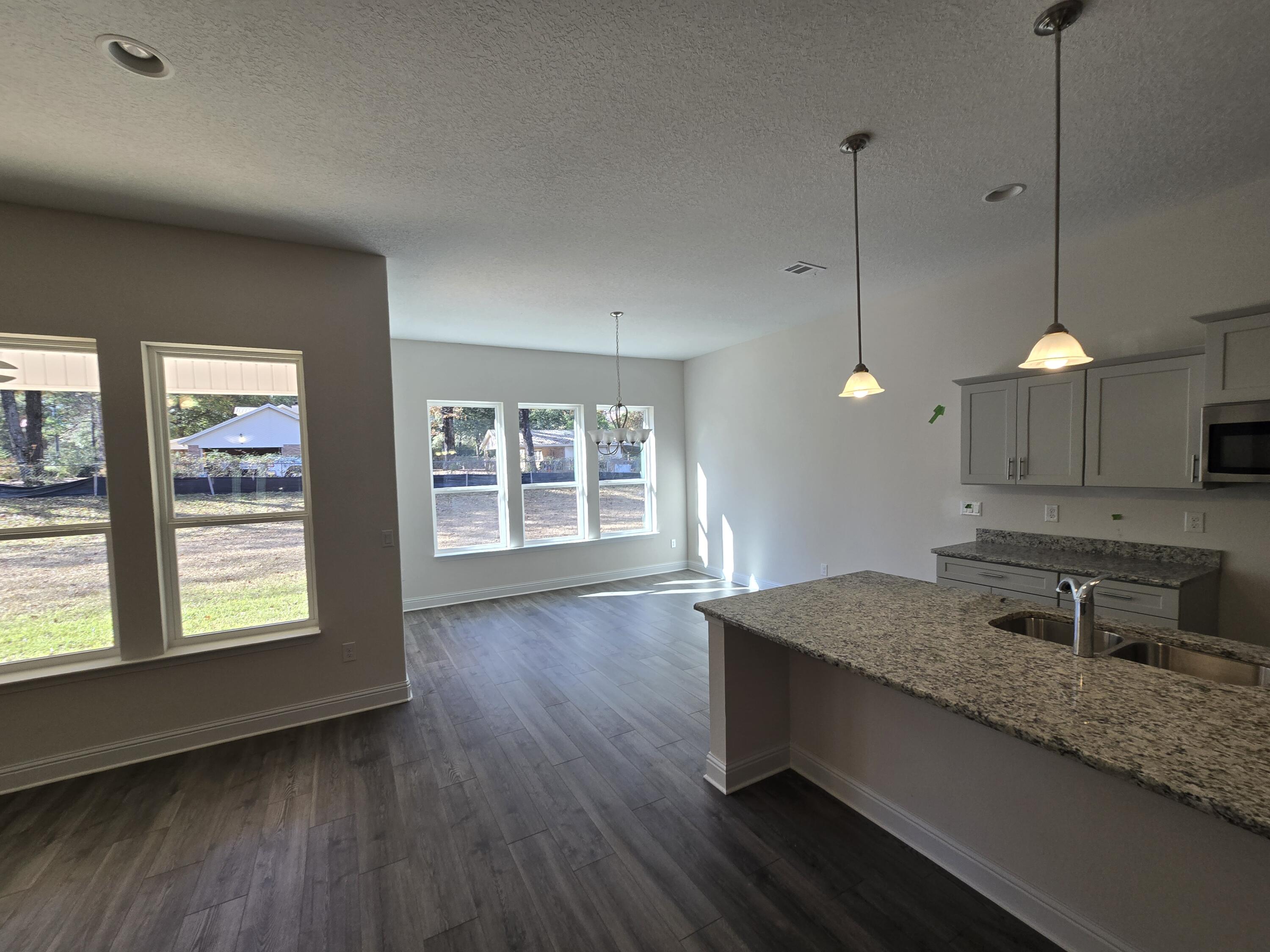 Seller Offering Buyer Incentive: $1 VA Move In or $25K Your Way
This is a limited contribution of up to $25,000.00 which can be utilized for Closing Costs, Prepaid Items, Interest Rate Buy down or Price Reduction with a Preferred Lender on Select Move In Ready Homes Closed by 3/28/2025  - Certain Restrictions Apply 

New Construction * 2x6 Exterior Construction* This Split Bedroom Plan features 4 Br/3 Ba & 3 Car Garage * Click n Lock Wood look Vinyl Plank Throughout Except Tiled Bathrooms * Kitchen has Granite Counter tops, Island & Stainless Steel Appliances & Walk in Pantry * Master Bath includes Signature Zero Entry All Tile Walk in Shower, Tile Flooring, Separate Soaking Tub, Double Vanities & Large Walk-in Closet * Ceiling Fans All Bedrooms & Family Rm * Covered Front Porch &  Rear Lanai *Sprinkler System * Builder Warranty & Structural 'Maverick' Home Warranty Included *