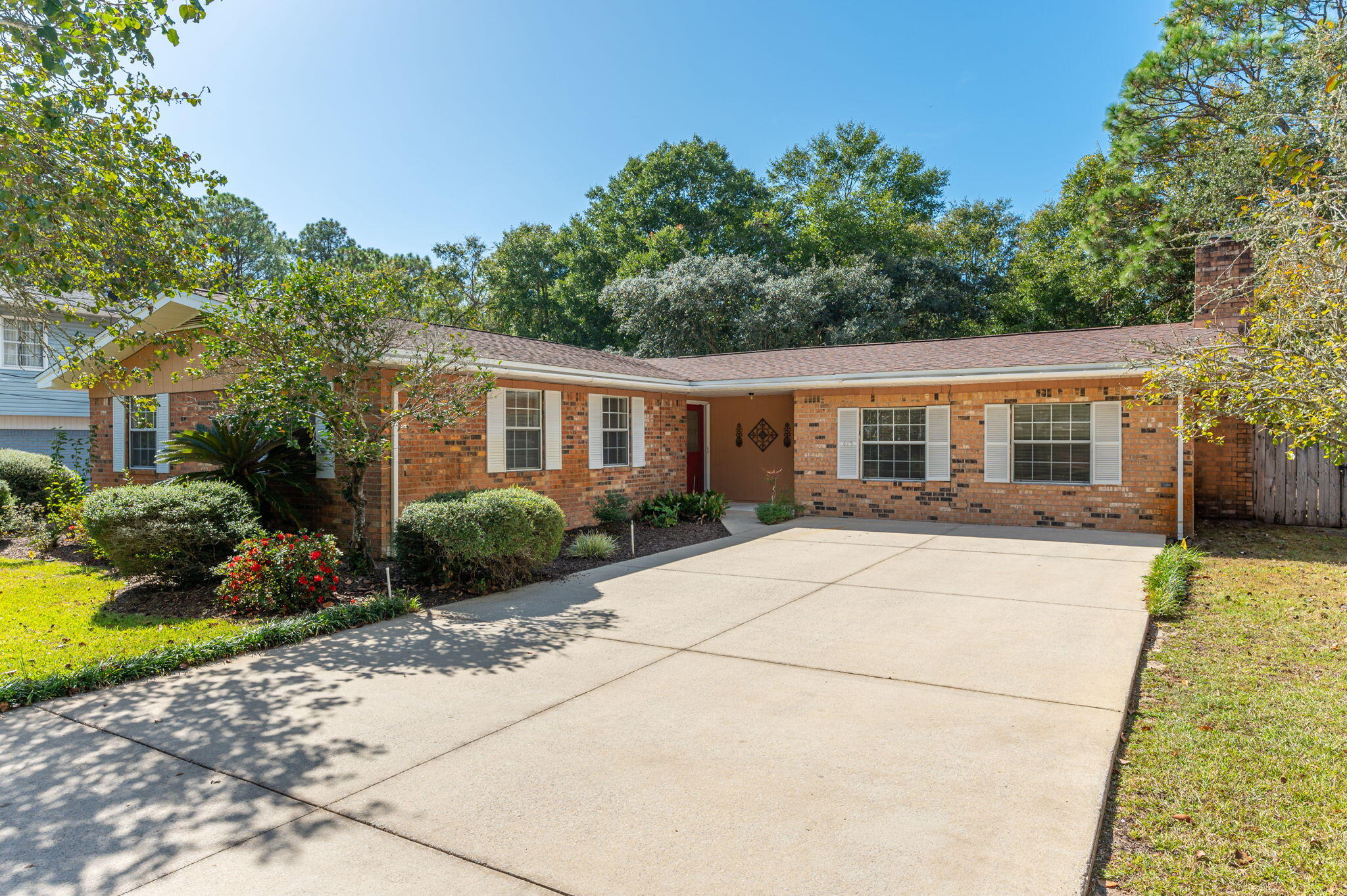 Come take a look at this well maintained brick home in Niceville with a pool! Situated on a beautiful lot with mature landscaping the driveway is wide enough to provide plenty of parking for you and your guests. The main living areas of the home have tile and laminate wood floors with new carpet in the bedrooms and great room. French doors lead to the family room where the focal point is the large stone wood burning fireplace accented with bookshelves on both sides. An eat-in kitchen has lots of natural light from the sliding door which leads to the open patio, wood deck and pool area. The kitchen features wood cabinets with a stainless steel refrigerator and stainless sink with garbage disposal, pull out trash can, smooth top electric range/oven and dishwasher. The separate dining room could also be used as an office, exercise room, etc. New lights and ceiling fans were installed in the bedrooms and the house was completely rewired and a new breaker panel installed in 2024. New GCFI breakers and smoke/CO2 detectors were also hardwired at that time. HVAC was installed in 2020, new hot water heater in 2024, new lawn pump for the irrigation (well) system in 2024, new vinyl pool liner 2024. There is a storage shed in the backyard and the interior of the home has been freshly painted.