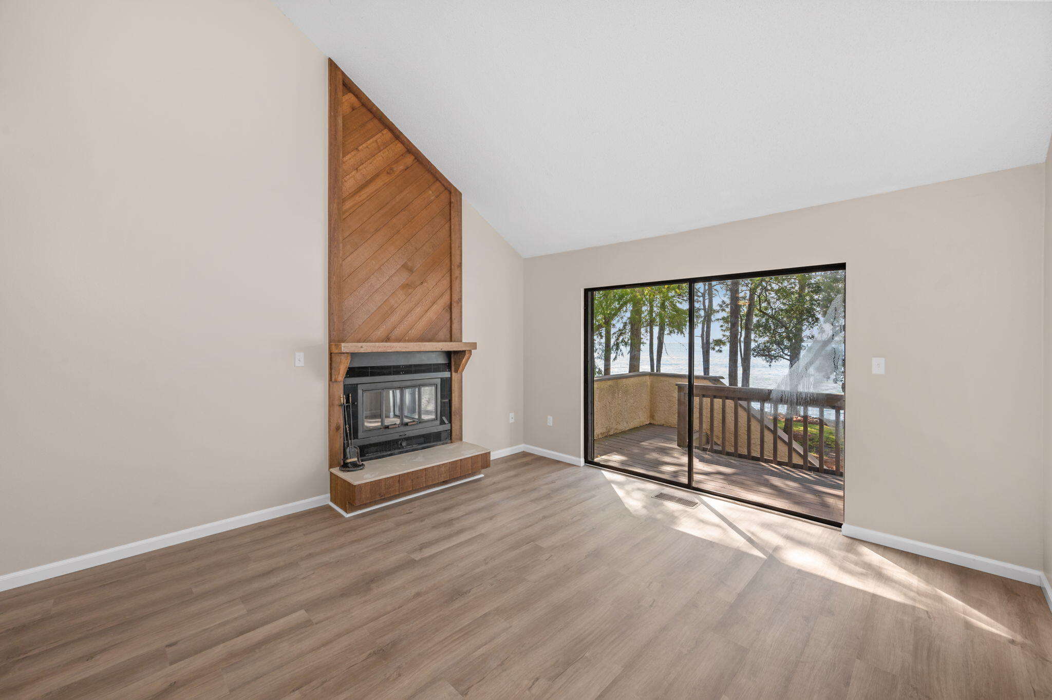 Enjoy stunning water views from all three levels of this beautifully updated 2-bedroom, 3-bath home. Featuring fresh paint, crisp trim, and luxury vinyl plank flooring throughout, this residence combines comfort and coastal style.
The renovated kitchen offers stainless steel appliances and a bright, open feel perfect for entertaining. The spacious living area includes a wood-burning fireplace, soaring multi-level vaulted ceilings, and access to a screened-in patio overlooking the water. The primary suite boasts a vaulted ceiling, walk-in closet, dual sinks with an extra-long vanity, and a separate water closet with a walk-in shower enclosed in glass. A second bedroom and full bath with a shower-tub combo provide plenty of space for guests, while a full bath on the main level adds convenience.
Additional highlights include a single-car garage with extra storage and access to Bluewater Bay amenities  including walking trails and marina access. Experience the best of waterfront living in one of Niceville's most desirable neighborhoods! Contact us today for a showing!