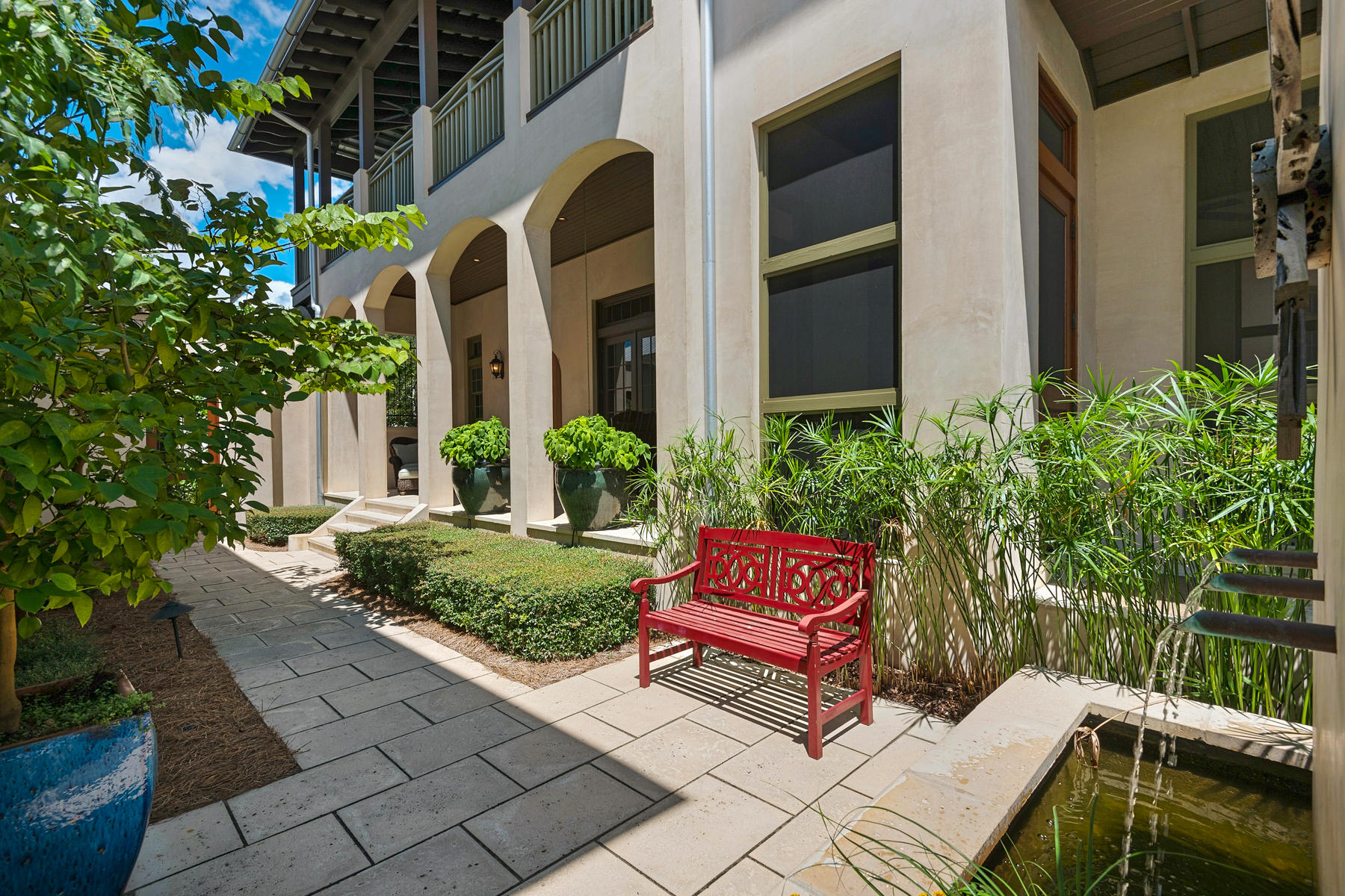 From the moment you first encounter this meticulously maintained 4 bedroom, 4.5 bath property, you will discover a spectacular residence beautifully decorated from top to bottom that is the ultimate entertainer's dream. The welcoming courtyards, private outdoor space with cozy fireplace, and spacious open floor plan flooded with natural light and high ceilings, makes this the home you've been waiting for. The Great Room and open concept gourmet kitchen with large island, granite counters and top stainless steel appliances offers a stylish contemporary ambiance. The first floor also boasts a sun drenched screened porch and private bedroom with bathroom, ideal for guests. Upstairs the oversized master suite with spa like bath provides access to the wrap around balcony with ample sitting ar for pure relaxation. Additional guestrooms include an adorable large built in bunk room with sitting area and bathroom. Truly one of the most pristine homes on the market today, this retreat also offers top amenities and just a short stroll to swimming pools, community parks and one of a kind beaches.