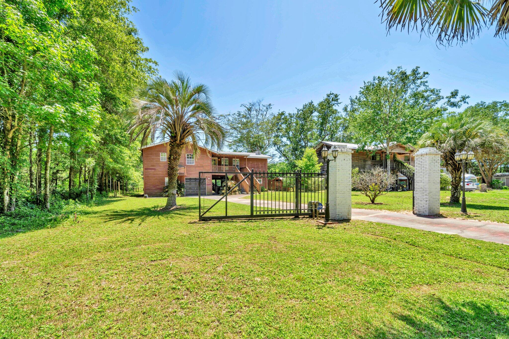 Seller's job transfer fell thru so Seller needs to sell. PRICED 25K BELOW 9/2025 APPRAISED VALUE!  AFFORDABLE WATERFRONT w/SEPARATE APARTMENT, Just 35 miles to BWB & < 30 miles to 30A!  NEW ROOF, HVAC, HWH, WELL & PUMP, & SEPTIC LIFT STATION provide affordable insurance & peace of mind. Tired of traffic & tourist traps? Dreaming of a peaceful retreat without giving up the beach & civilization? Ideal as a primary Home, 2nd home, or investment property, this Cedar Sided, 2 Story RIVER CAMP on .21 acre serene landscape is Calling Your Name!  Spend your days gazing out at Choctawhatchee River, taking a boat or jet ski out for a ride, or fishing right from your deck. A soaring ceiling, original hardwood floors & giant open-concept living area accent the 2nd-Floor Primary Residence (1,440 SF) The huge living space w/cozy wood-burning fireplace & custom built-in bookcases flows seamlessly into the updated kitchen with multiple dining areas, ideal for both entertaining and daily life. The spacious Kitchen Island Bar, topped with lovely granite, is the perfect spot to watch the chef in action or gather with friends. The kitchen includes ample storage in white wood cabinets, SS appliances, side-by-side refrigerator, deep double-bowl sink & dishwasher. Tucked off the kitchen is the Master Bedroom with an En Suite remodeled Bathroom w/ new vanity, toilet & tiled walk-in shower. A laundry area with washer and dryer hook-up is also included.

From the back of the home, enjoy sweeping river views, a picture-perfect backdrop for everyday living. This truly special home embraces the outdoors with multiple outdoor living areas designed for relaxation. Turn the 2nd floor screened porch into a secondary living area or additional bedroom, or step onto the expansive covered deck to unwind and take in the awesome views.

On the ground level, relax on the covered porch swing or step out to the massive deck extending the majority of the 71 feet of river frontage. Fish, relax, or even add a dock for your personal watercraft, the choice is yours.

The Ground Level also features a separate 1-bedroom, 1-bathroom apartment with a walk-in closet, space for a kitchenette, & a screen-covered porch. An additional Separate Bonus Room could be used as an Office, Bunk Room, Hobby Space, or overflow Storage.

An extended-length 1-car garage provides plenty of room for a vehicle, & possibly even an ATV or side-by-side. The property has its own private well with a filtration system located in the outbuilding and is on septic. 

Don't be fooled by this serene location, this Home Offers Close proximity to Freeport, Niceville, Beaches, Grand BLVD & 30A! Plan a visit right down the road to Tree House Farms, a local Organic Farm, offering fresh produce & a stunning backdrop for weddings & private events. Plan a Picnic or Launch a Watercraft for the day cruising the Choctawhatchee River, at Cowford Landing Park & Boat Launch. 

Explore the possibility of turning the home into an AirBnB or rental property for others looking to escape! Learn about the uniqueness of our ecosystem at E.O. Wilson Biophilia Center. Make a playdate with a four-legged friend at Alaqua Animal Refuge. Spend the day at the Beach or Explore one of the State Parks!

Seclusion with Close Proximity to it ALL!
Tree House Farms - Local Organic Farm & Wedding / Private Event Space located 1.9 miles
Cowford Landing Public Park & Boat Launch - 4.8 miles (245 Big Cedar Rd) Offers Boat Launch, Screen Covered Deck, Public Restrooms, & Picnic Tables
Alaqua Animal Refuge - 9.2 miles
E.O. Wilson Biophilia Center - Just over 10 miles
Publix Super Market at The Shoppes at Freeport - 14.3 miles
Eden Gardens & Point Washington State Parks - within 28 miles
Grayton Beach - 27.5 miles
Rosemary Beach - 30.6 miles
Grand Blvd 32 miles
ECP Airport 22 miles
Closest Public Beach Access 58 Panama City Beach - 23.4 miles
Blue Mountain Regional Beach Access - 26.9 miles