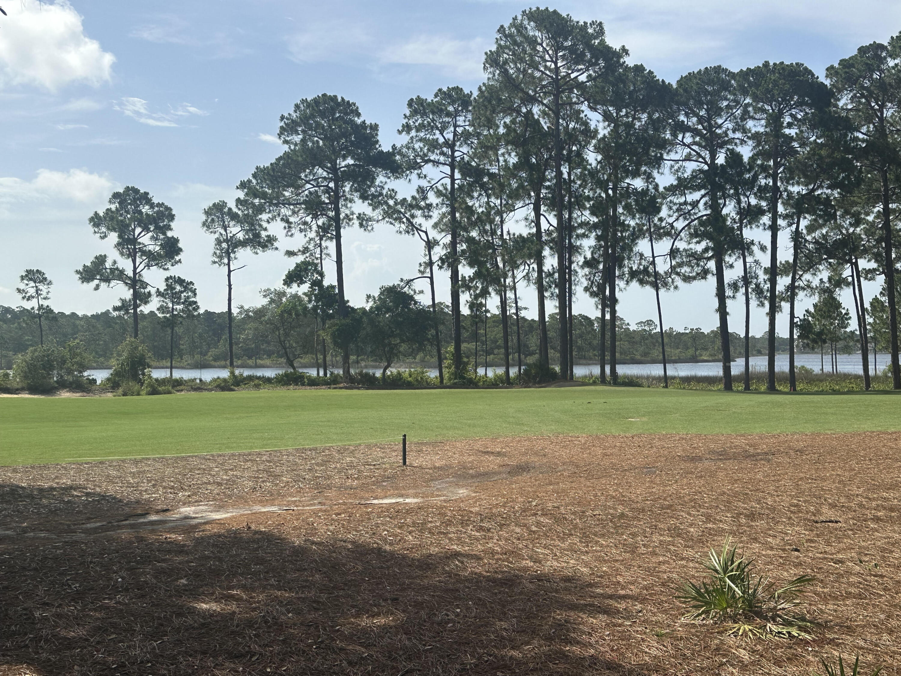 Leave the bustle of tourist traffic and  30A behind and come home to the tranquilty of Wild Heron.  Just minutes from 30A and Pier Park, this EPIC lot sits alongside the 6th fairway of the acclaimed Sharks Tooth golf course and has STUNNING views of Lake Powell.  it is truly one of the very BEST lots in Wild Heron.   At almost 2/3 of an acre, you can build a very large home with a large pool and backyard sanctuary.  PLUS, a  leased BOAT SLIP, at the amazing Wild Heron marina, conveys with the purchase of this lot.  Preliminary home plans have been produced and can be provided with the sale.   GOLFING, BOATING, FISHING, or just RELAXING with great neighbors, you have found paradise and can call it HOME!  Before a contract, a free onsite consultation with an approved Wild Heron builder and and architect can be arranged to help make your dream come to life!   This amazing coastal sanctuary borders Lake Powell, the largest coastal lake in Florida and you will feel the peaceful atmosphere as soon as you drive in.  Just minutes from 30A, beaches and Pier Park, this exclusive gated and guarded community is luxury living at its finest with incredible amenities and the renowned private membership, Greg Norman designed Sharkstooth at Watersound golf club.   Amenities include a large, heated community pool, hot tub, large gym, boathouse, dock on Lake Powel - the second largest brackish lake in the world, fire pit, trails, event lawn, and other.  Wild Heron is a very social neighborhood with summer concerts, holiday parties, weekly food trucks and farmers market, yoga, dance exercise, water aerobics, and many other activities.  Watersound Club is available to join and includes not only the acclaimed Sharkstooth Golf Club and the new "Third" Links golf course, but access to Camp Creek golf course, Camp Creek Inn w/Pool and gym, the Watersound Beach Club, Clay shooting course, and on-site clay lighted tennis courts.  You are only a few minutes from Beach access 87 which is right down Kelly Street.  Sunsets on Lake Powell are amazing and fishing, boating, kayaking and paddleboarding are frequent activities.