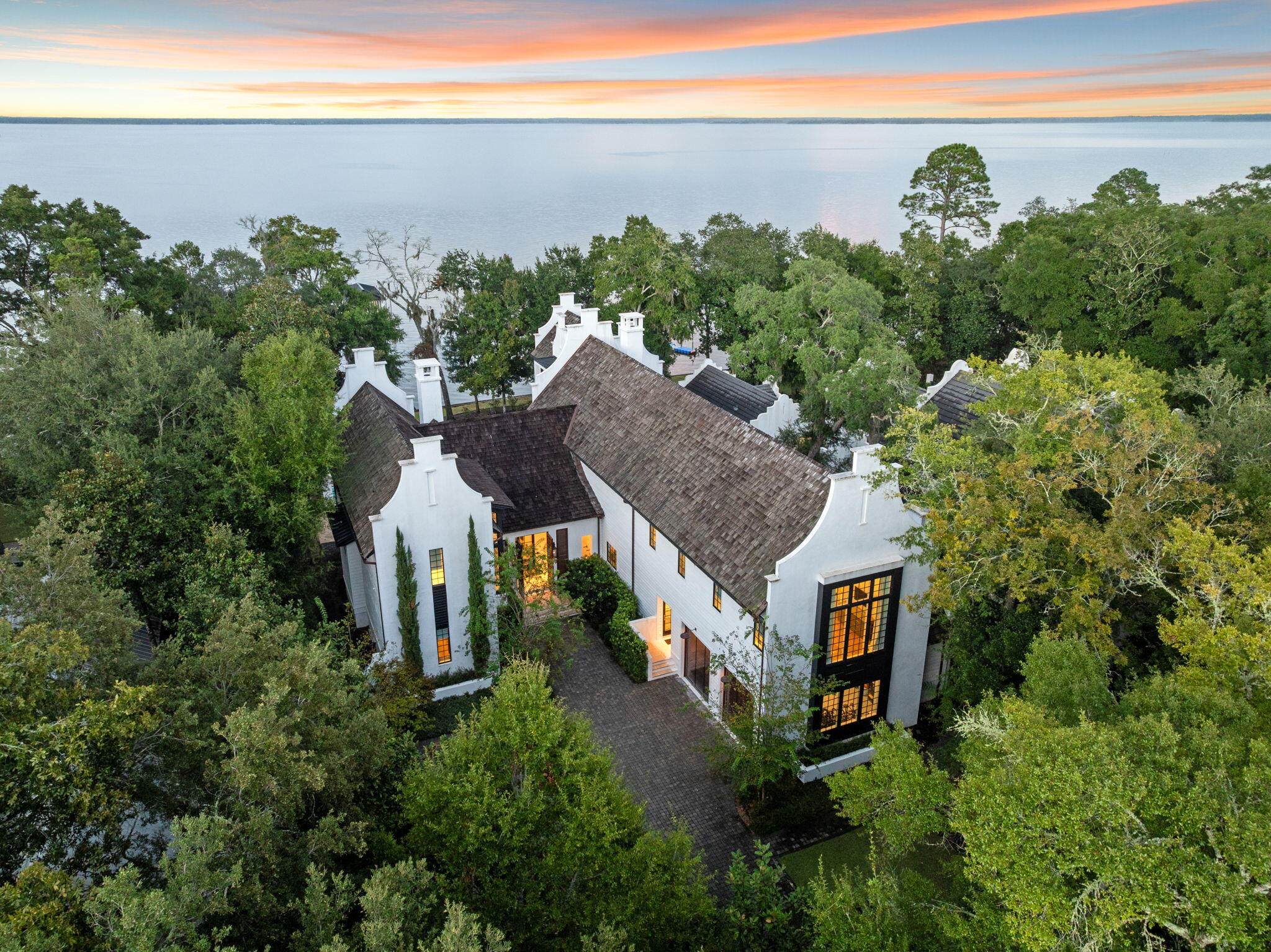 Welcome to The Estuary, aka 30A on the Bay. This coveted gated non-rental community is surrounded by preserved land in Point Washington with tree lined streets, just minutes from the beach. 147 Ansley Forest Drive, designed by Tyler Doin and built by Regal Stephens Construction, offers street appeal like no other. At 7648 square feet, this home sits on .6 acres with 106' of bay front and offers 6 oversized bedrooms, 6.5 bathrooms, and sunlight galore. If waking up to the sounds of water crashing on the seawall and birds chirping, while watching dolphin swimming by your private boat dock, is your idea of a dream life, then this is the home for you. The house has only the highest end marble, gorgeous tile from Qtile, designer lighting throughout, and designer wallpaper from Kelly Wearstler and Phillip Jeffries. Walnut floors, Venetian plaster, and beautiful custom doors and cabinetry bring this home to a whole new level of style and sophistication. This home offers water features in the front and back, an oversized movie theater, gym, and a private pool house with a large 25' x 45' pool/spa. Like to cook and entertain? The kitchen is a chef's dream kitchen with Wolf/Sub-Zero appliances throughout and a gorgeous glass wine cellar at the center of it all. You'll never want to leave.