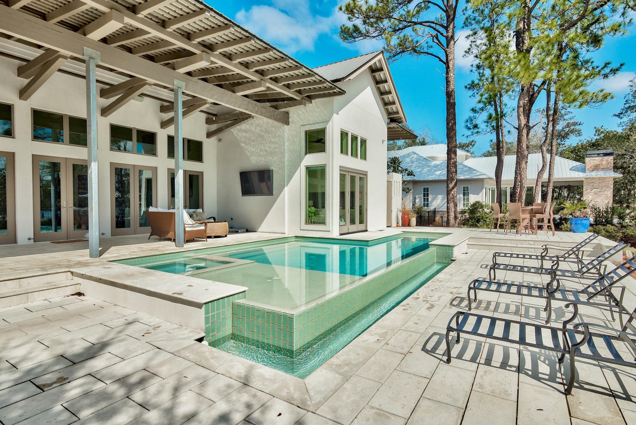 430 Botany Boulevard is located in the gated community of Botany Bayou ideally situated between Miramar Beach & Scenic 30a. Natural beauty abounds on the wooded lot of mossy oaks, mature magnolias and shrubby palmettos. Boat dock and lift along with additional jet-ski lift enable boaters to take full advantage of life on the water from Day 1.The Modern-inspired design of this contemporary beauty are realized before even stepping foot inside. White concrete with tan accents and clean lines create eye-catching curb appeal. Upon entering the home, you become immersed with the idea of bringing the beauty of outdoors inside. The 24 foot cathedral ceiling allows for a wall of french doors with oversized transoms to brighten the home with natural light The view from the kitchen and living room is stunning as it overlooks the negative edge, custom-pool/spa and the smooth current of Mack Bayou. 

The kitchen features top of the line Wolf and Sub-Zero appliances including induction stovetop, steam oven and "Sonic" ice machine in the Butler's Pantry. In the master bedroom it is difficult to decide which attribute makes the room so cozy and appealing. The roofline of the home creates a beautifully interesting ceiling line and the elegant accordion doors once again create the invitation of bringing nature indoors. In the master bathroom you will find expansive double sink vanity, oversized walk through shower into the outdoor shower, deep soaking tub overlooking the backyard and generous master closet with custom shelving & cabinets. Off of the master bathroom there is an ample workout room before arriving to the office space.

Upstairs are two additional bedrooms with large, accommodating closets and private bathrooms. Approximately 900 square feet of finished space above the two-car garage is ideal for game-room & theater or an additional master suite.