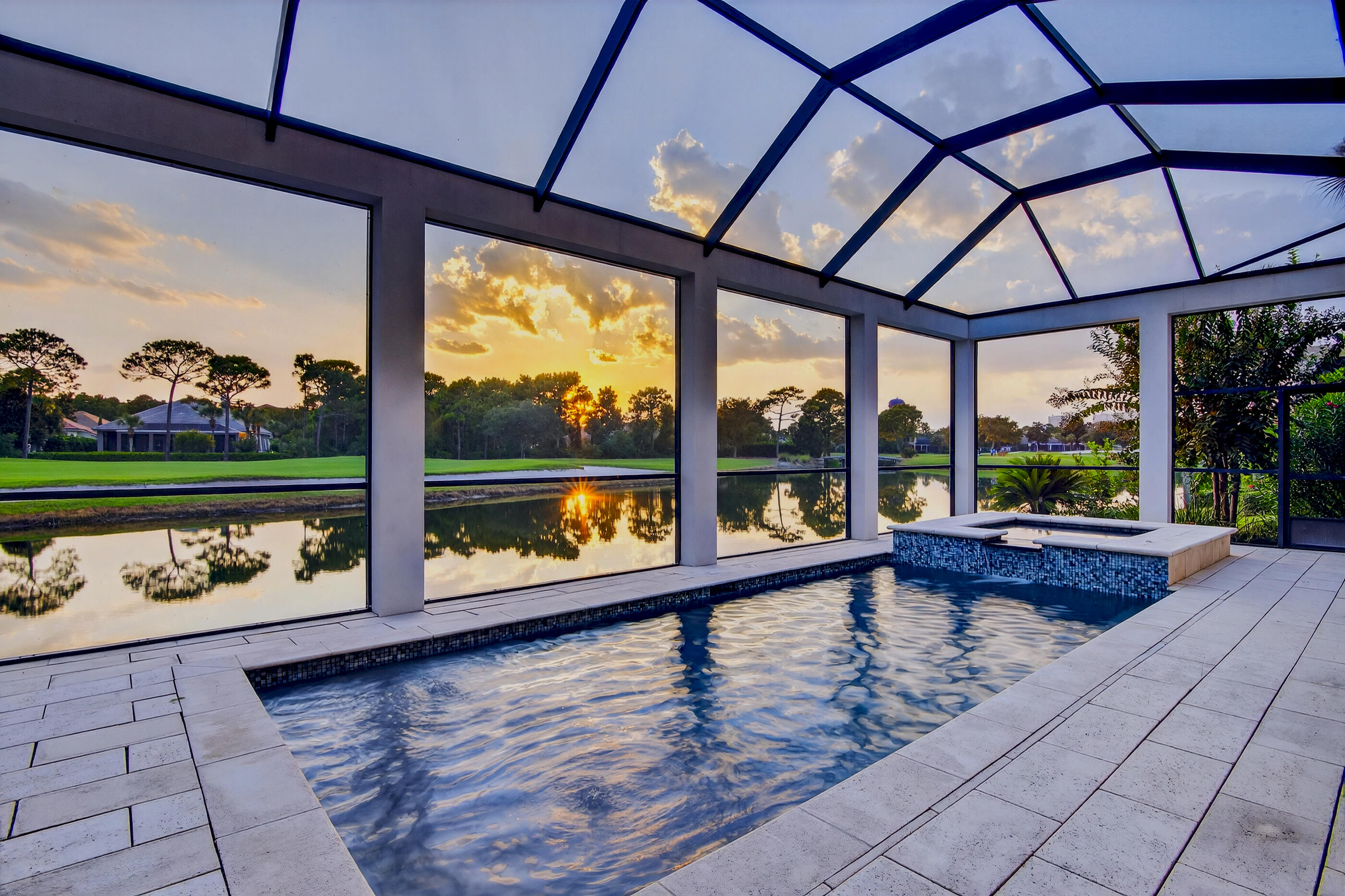 Priced below recent appraisal!  Discover the perfect fusion of modern elegance and artistic coastal contemporary design in this remarkable lakefront residence.  This newly built home sits on one of the premier lots in Regatta Bay and offers both lake and golf course views.  The home is located  within the prestigious gated golf and boating community of Regatta Bay. Completed in 2016, this meticulously designed home showcases an open floor plan with the majority of the home located on the main level.  The thoughtfully arranged layout features four bedrooms and four and a half bathrooms, enhanced by clean lines and exquisite designer finishes throughout. This designer finished property boasts remarkable features, including soaring 12-foot ceilings on the main level and an oversized three-car garage with ample parking. The interior showcases elegant hardwood flooring throughout, leading to a spacious living room that is anchored by a contemporary gas stone fireplace. This inviting space offers seamless access to an expansive screened lanai, showcasing 650 square feet of outdoor living space adorned with pecky cypress ceilings and beautiful views. The outdoor area is further complemented by a secondary gas fireplace, pool and hot tub, perfectly positioned to capture breathtaking western sunsets and picturesque views of the lake and multi award winning golf course. The designer kitchen is a culinary dream, with custom built cabinetry, Calcutta marble countertops, 60-inch Wolf gas range and a built-in Sub-Zero refrigerator. The kitchen flows effortlessly into the open dining room and includes an oversized pantry with premium storage options. The master suite radiates coastal charm with and a spa-like master bathroom complete with a luxurious soaking tub, dual vanities, chevron-pattern marble flooring, and an oversized walk-in shower adorned with hand-hewn beam accents and dual shower heads. The 13x16 master closet is a standout feature, offering direct access from the master suite and showcasing custom-built shelving along with a center island for optimal storage. Additionally, the laundry room conveniently connects to the master closet for enhanced functionality. On the second floor, you will find two additional bedrooms each with en-suite bathrooms, as well as a flex space. Regatta Bay is a serene, gated community that seamlessly blends golf and boating, offering a lifestyle that is truly unparalleled! The essence of the Regatta Bay Lifestyle revolves around convenience, allowing residents to easily access numerous enjoyable destinations within minutes via golf cart, including the beach! Within the community, residents can indulge in golf, swimming, tennis, pickleball, parks, playgrounds, the Regatta Bay Clubhouse, Legendary Marine, and Legendary Yacht Club. Furthermore, Regatta Bay features a private road that leads directly to the Destin Commons, where an array of popular retail stores for both men and women awaits, alongside a diverse selection of restaurants, Whole Foods, Bass Pro, Lowes, an AMC movie theater, and Uncle Buck's Bowling-all easily reachable by golf cart. Regatta Bay is centrally located offering easy access to the airport and only a few miles from Northwest Florida's finest hospital.