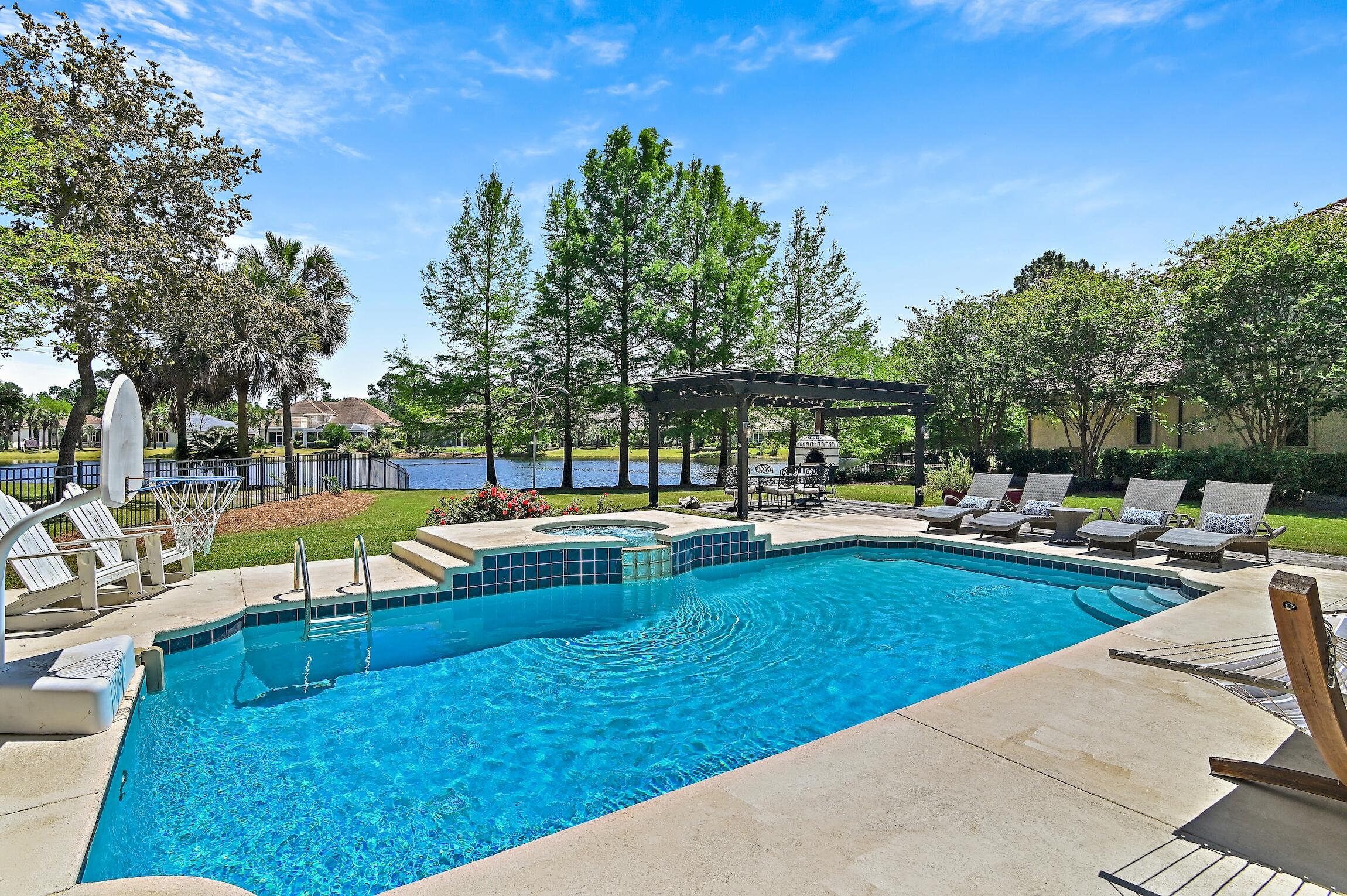 Welcome home to this large Southern Traditional designed family home, located on a quiet lake in the exclusive gated golf community of Regatta Bay. A NEW CONCRETE TILE ROOF HAS RECENTLY BEEN INSTALLED AND BOTH WATER HEATERS REPLACED! The back exterior is a nature lover's dream, offering heated private pool and spa, custom pergola, and a gorgeously landscaped fenced yard all overlooking the private lake. The main level offers a formal living room, den, dining room, office, half bath, and an attractively updated kitchen featuring Wolf and Sub-Zero appliances and quartz counters. The owners also added an enclosed custom built back porch featuring a built in grill, kitchenette, and a wood burning fireplace. The second level of the home offers 4 bedrooms, all with their own en-suite private bathrooms. The master bath has gone through an extensive renovation to include a large walk-in shower and standalone tub. Over the garage is a 5th bedroom with it's own bath that makes for a perfect guest suite or home gym. Regatta Bay is Destin luxury living at it's finest. Some of it's amenities include a 6,894-yard, par-72 course named one of Golf Digest's "Top Places to Play in North America", clubhouse offers first-class dining, tennis courts, community pool, playground, and walking paths. There is a private gated entrance on the North side offering easy access by golf cart or car to the Destin Middle School, as well as Legendary Marine and Yacht Club! The Destin Commons Shopping Center as well as Whole Foods are easily accessible by golf cart without every having to get on Highway 98. And don't forget, the beach on Scenic Hwy 98 is just a mile away and is also accessible by golf cart! Buyer to please verify all information contained herein.