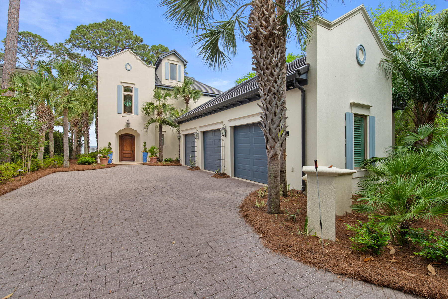 PRICE REDUCTION! This is the best priced bay front property on the market - must see! ''Elegance on the bay'' describes this 5,189 square foot custom Mediterranean residence located in picturesque Burnt Pine at Sandestin Resort.  With stunning views of the Choctawhatchee Bay, this opulently designed home is perfect for entertaining.  West-facing landscaped grounds feature lush greenery, palm trees, a fenced backyard, and a new dock with views of Mid-Bay Bridge across the bay. 
The entry hall features a grand staircase and leads to the great room with a chateau style fireplace and lovely bay views. Expansive sliding glass doors open from the great room to a cozy screened porch with an additional fireplace. The chef's kitchen and butler's pantry feature bespoke cabinetry, a center island, a breakfast bar and appliances designed for precision cooking plus an ice maker, wine refrigerator, and an extra refrigerator. For convenience, there is a wood paneled elevator that services all three floors. The three-vehicle garage features new epoxy flooring and offers ample space for kayaks, paddleboards, and a golf cart.
The first floor primary suite is designed with a bay window sitting area and a luxury primary bathroom. Located on the second floor are four family bedrooms including a second primary suite, and three private bathrooms. The second floor balcony may be accessed directly from three of the family bedrooms. A second laundry room and coffee bar are also located on the second floor. The third floor offers office space, a wet bar, a half bath and stunning bay views. Recent updates include a new tile roof (2024), a Kohler whole house generator, instant water heaters, enlarged patio, fenced back yard, 2 jet ski lifts, remodeled powder room, new light fixtures, new Speed Queen washer and dryer, exterior paint, epoxy garage floor, and an  upgraded alarm system. Owners have access to Sandestin Golf and Beach Resort amenities like the beach, the SOA swimming pools, golf, fishing, shopping, entertainment, and upscale dining.
