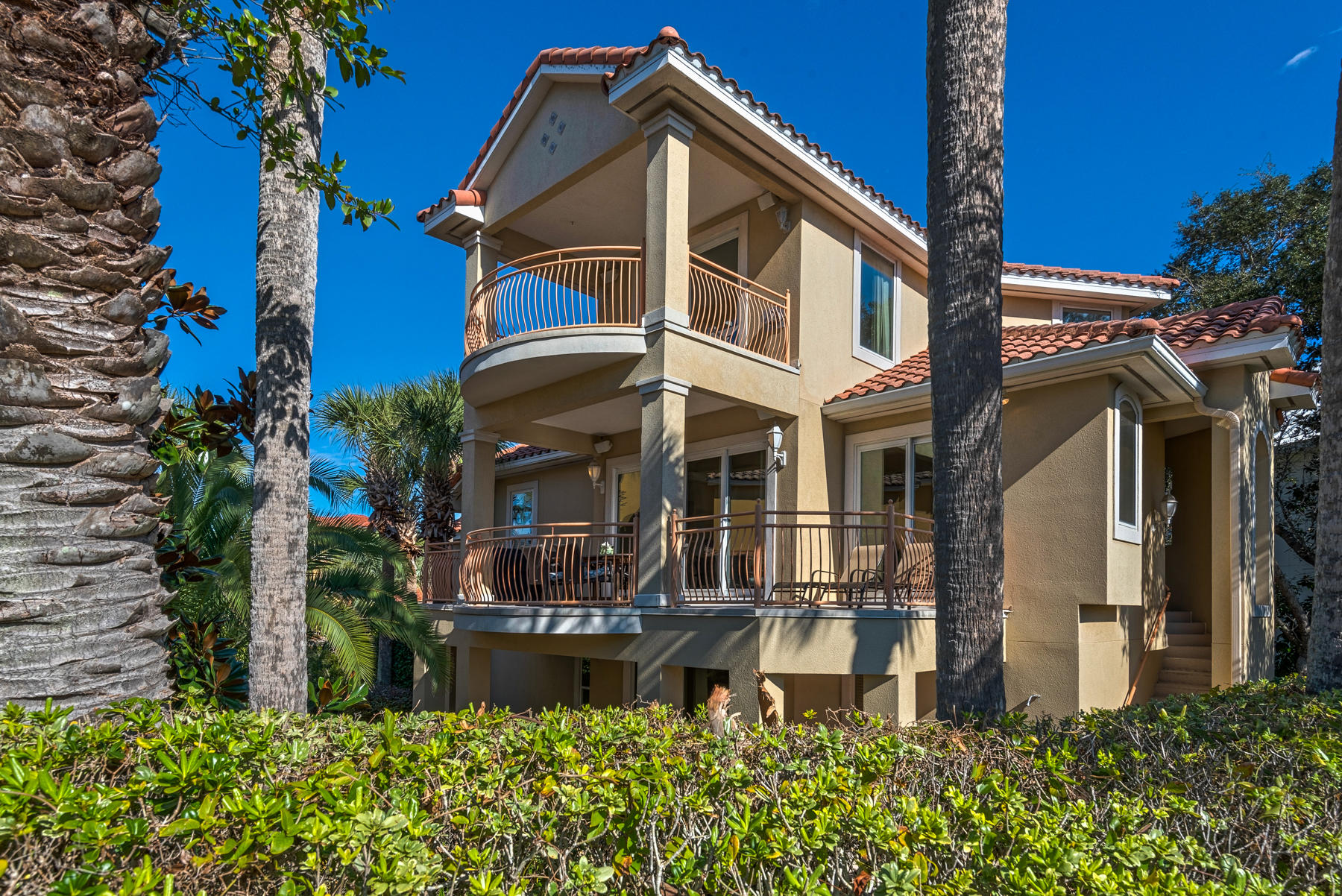 Currently appraised at $1.14M. Elegant custom home with permanent Gulf views and distinguished interiors in Destiny East exemplifies the finest of Florida living. Priced below appraisal, this Mediterranean-inspired home is only 80 steps to the neighborhood pool and just a short stroll or golf cart ride to the public beach access. The floor plan is carefully planned with living spaces on two floors and private baths with all six bedrooms. High ceilings and superb detailing enhance light-filled interiors. Unique details include: rounded bull corners, extensive crown molding, hardwood & tile flooring, 2 fireplaces, a dumbwaiter servicing all levels. The open-concept kitchen with wine storage, 5-burner gas cooktop, large island, plenty of workspace, and large breakfast bar is meant for gathering and entertaining. Three levels of deluxe porches welcome salty breezes and sunset views. The spacious master suite offers incredible beach views from its private terrace and large windows. The lot is 9,583 sq ft., and the large backyard could accommodate a nice pool. This home's desirable location, and generous guest accommodations would make it a great vacation rental, second home or full time residence. Strong rental potential of $139,900 with updates and a pool. Destiny East is an exclusive gated community with a wonderful clubhouse, two community pools, two lighted tennis/pickle ball courts, fitness center, playground and private movie theatre. It's central location provides easy access to all Destin has to offer.