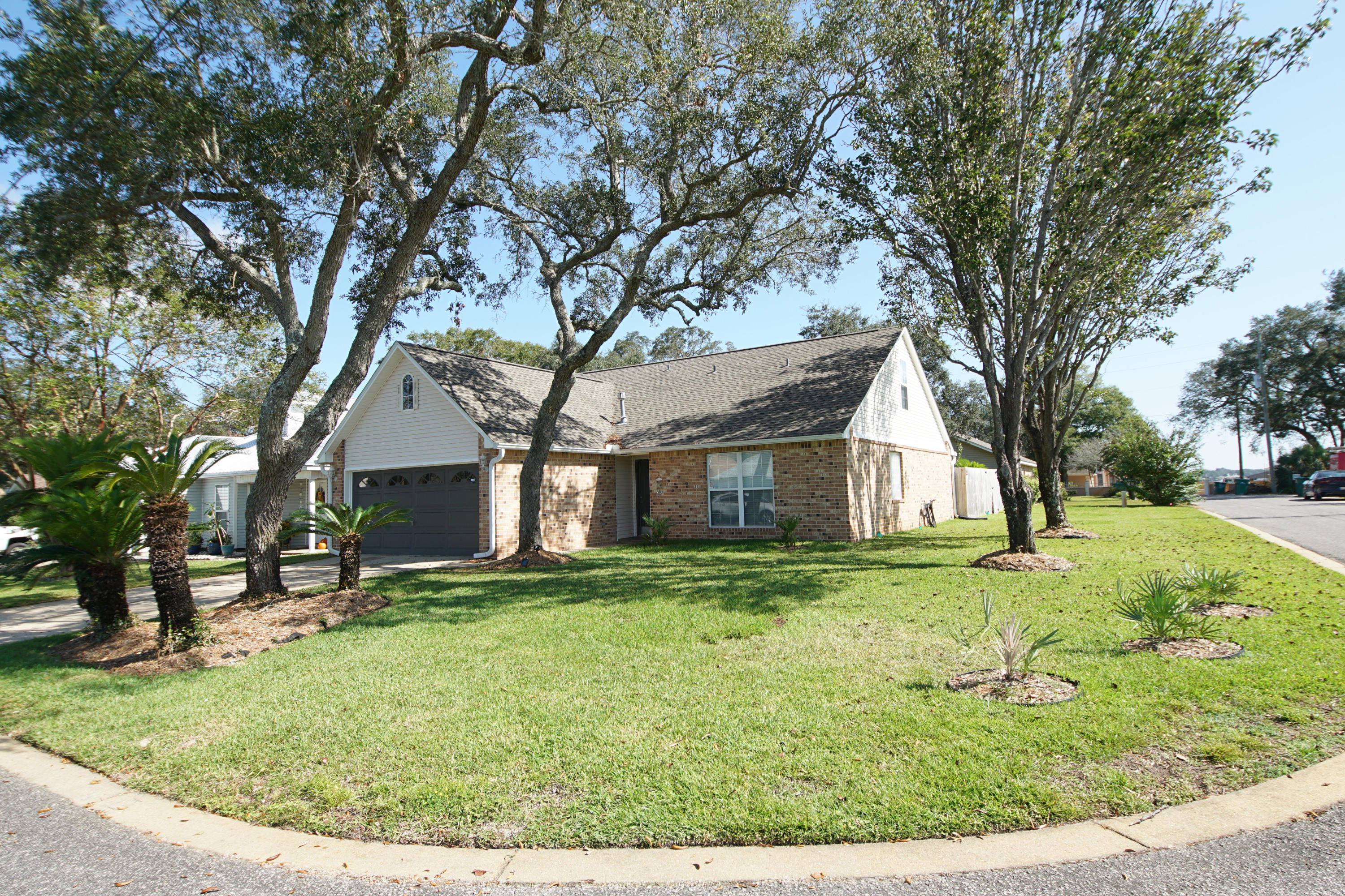 Heart of Fort Walton Beach in quiet neighborhood. On large corner lot Great floor plan with 2 bedrooms and loft upstairs. Fourth bedroom and master bedroom downstairs. Updated kitchen and bathrooms. Master bath has large custom walk-in shower. Main living room has wood burning fireplace. The front & back yards have been landscape with mature plants that capture the essence of this exquisite home.. Attached 2 car garage. Pets may be allowed with owner approval and non refundable pet fee. No smoking.